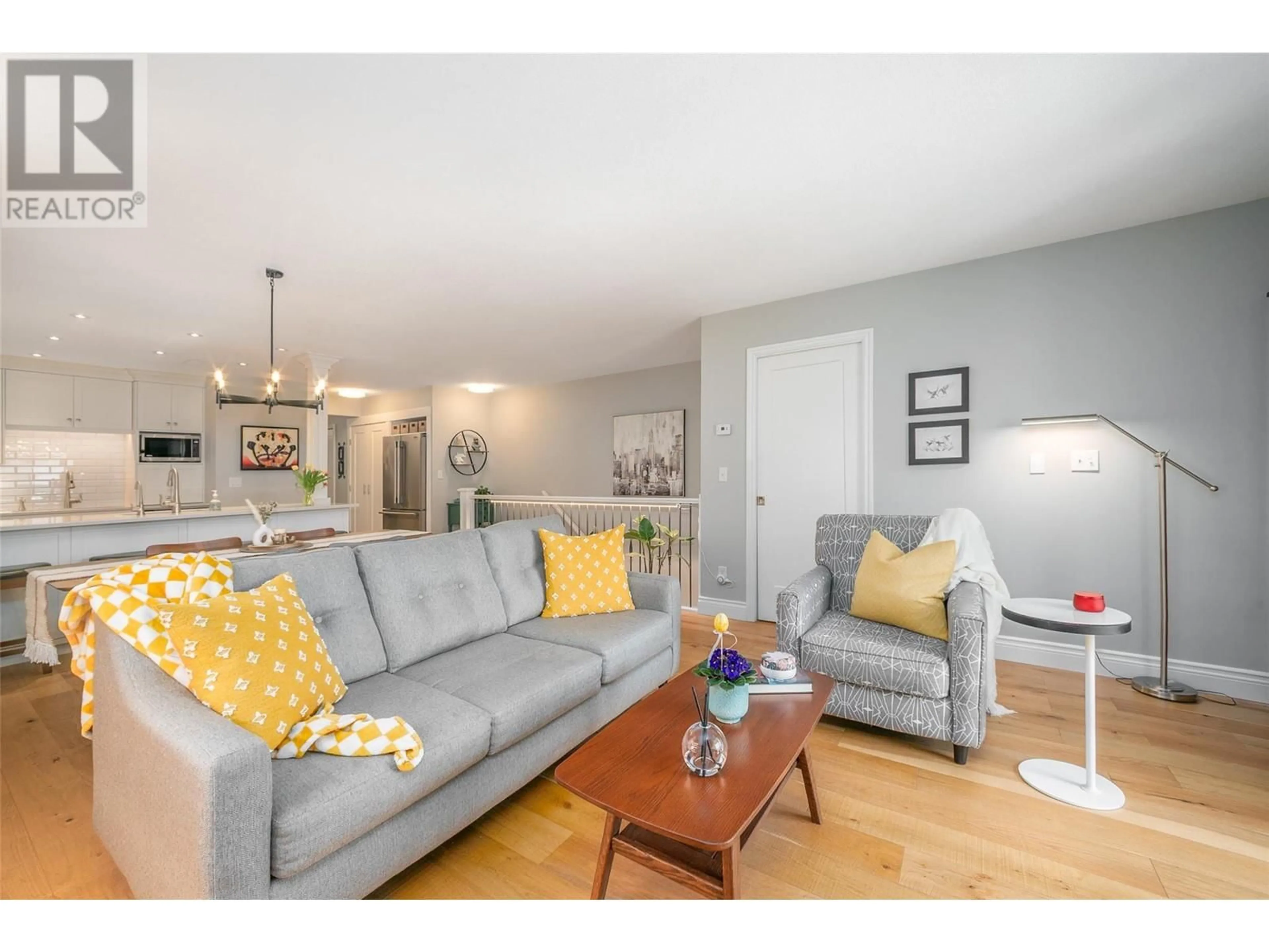 Living room with furniture, wood/laminate floor for 216 - 2350 STILLINGFLEET ROAD, Kelowna British Columbia V1W3X9