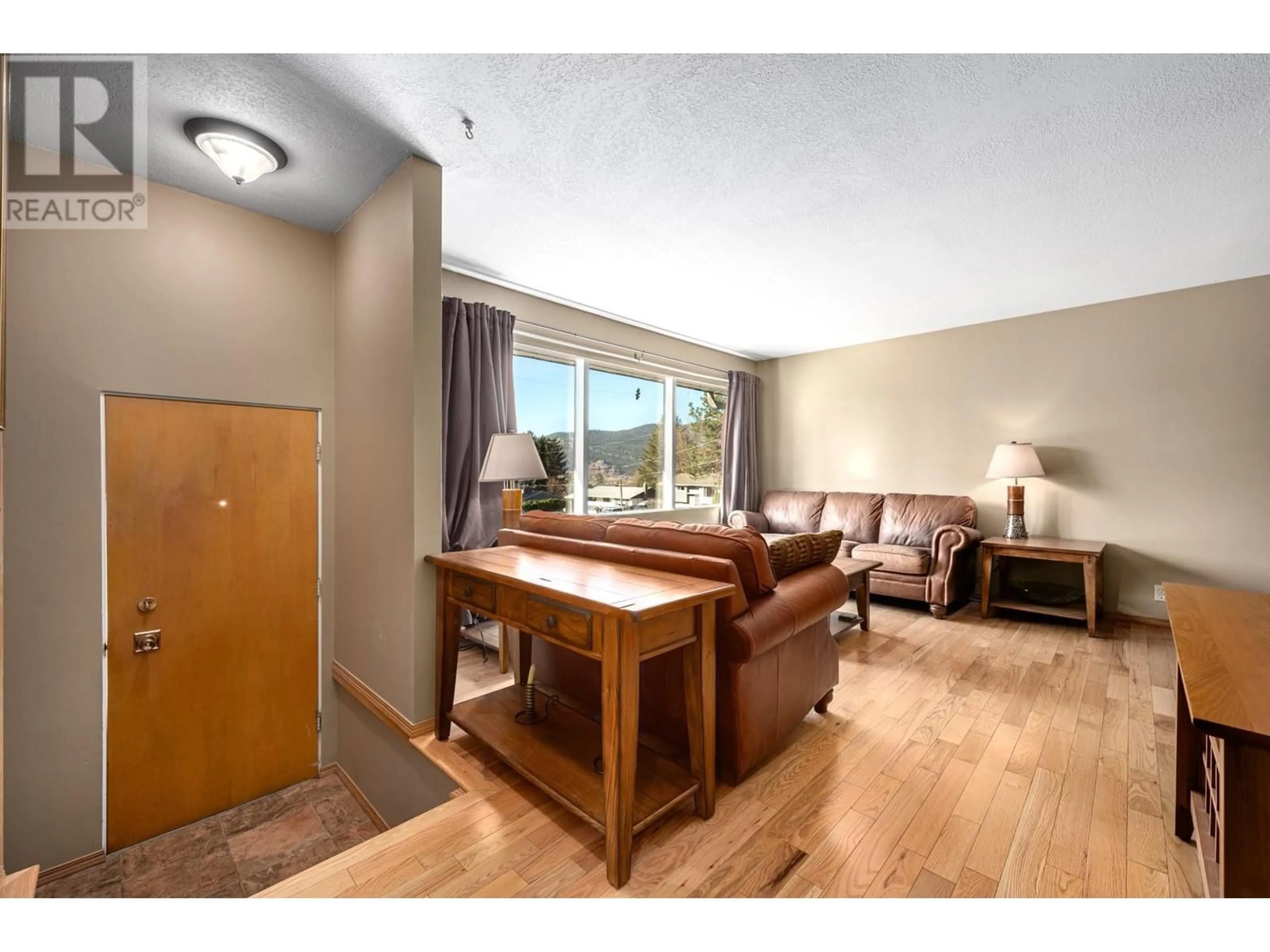 Living room with furniture, wood/laminate floor for 3381 BOYD AVENUE, Merritt British Columbia V1K1J3