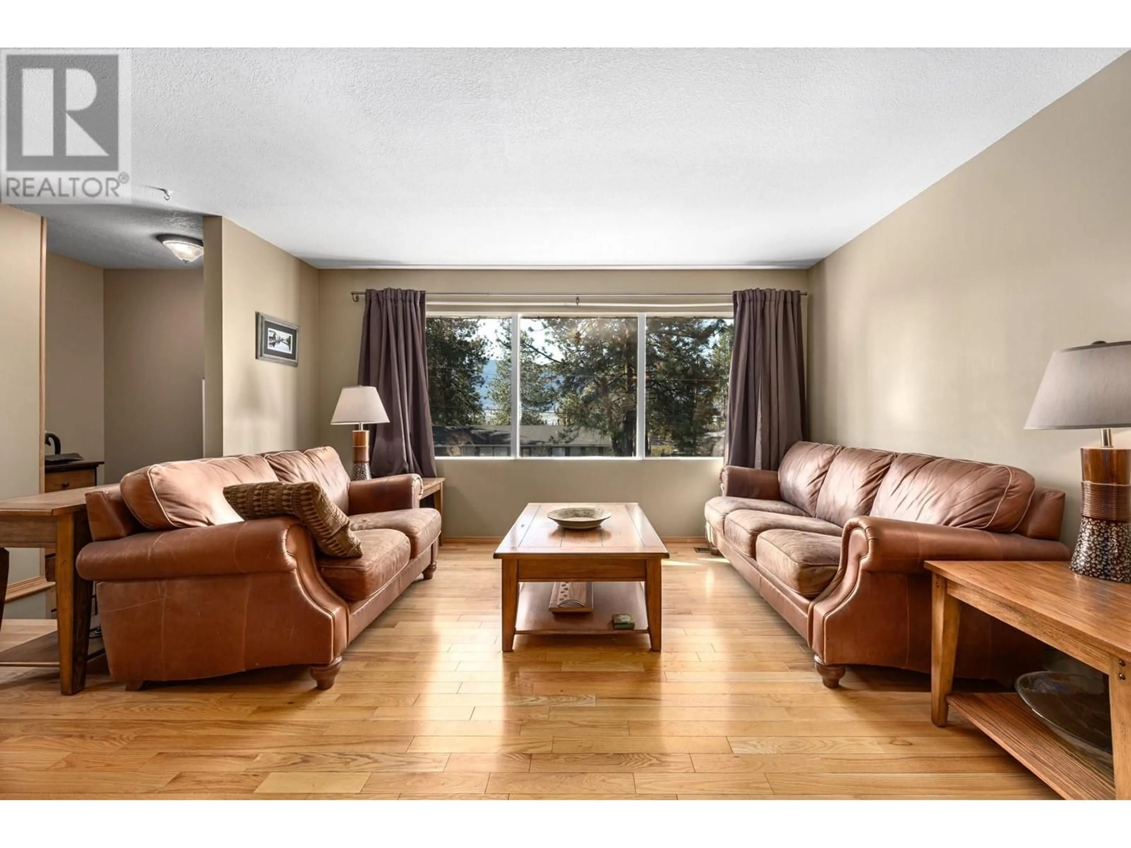 Living room with furniture, wood/laminate floor for 3381 BOYD AVENUE, Merritt British Columbia V1K1J3