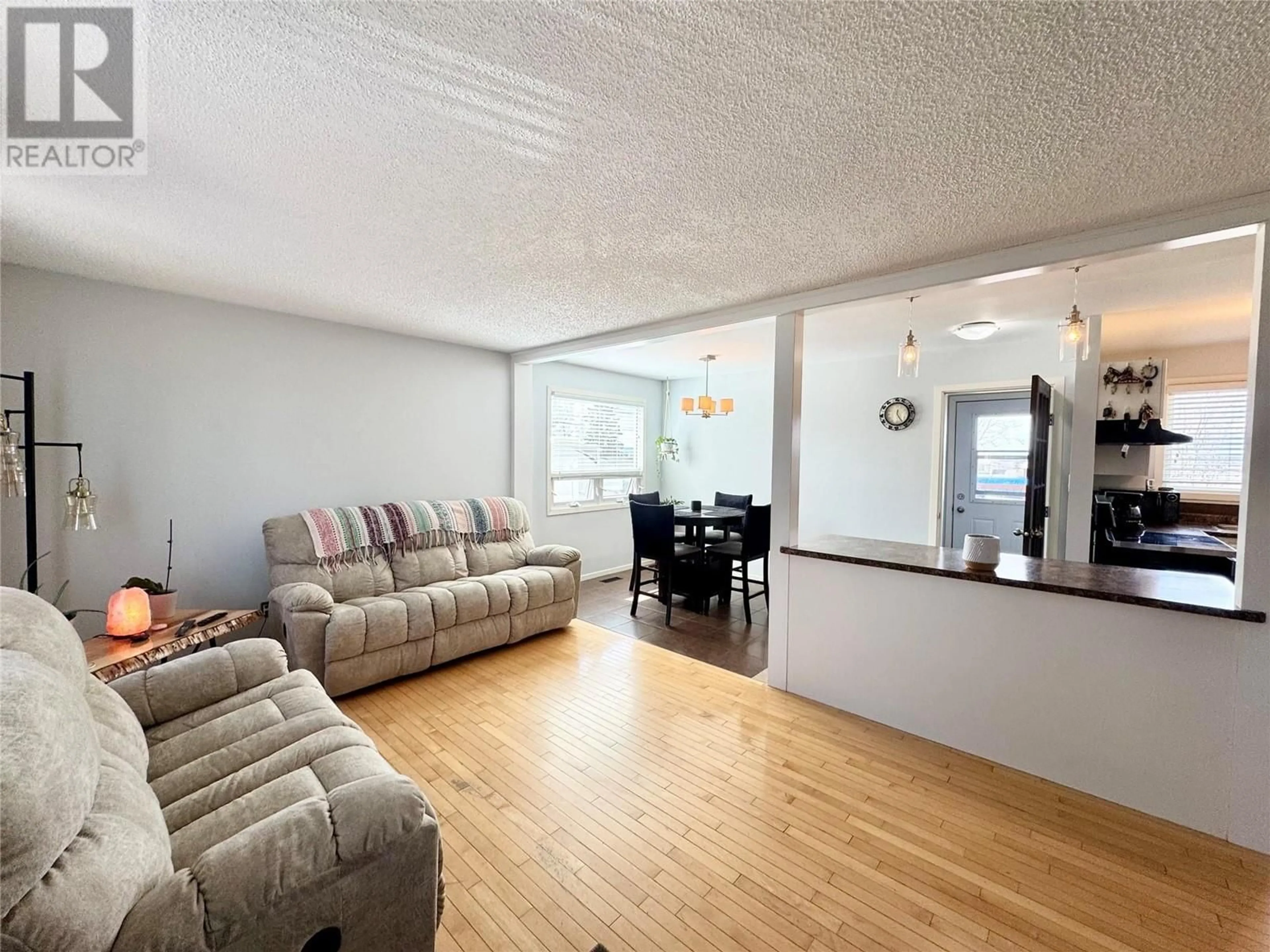 Living room with furniture, wood/laminate floor for 9425 6 STREET, Dawson Creek British Columbia V1G3L7