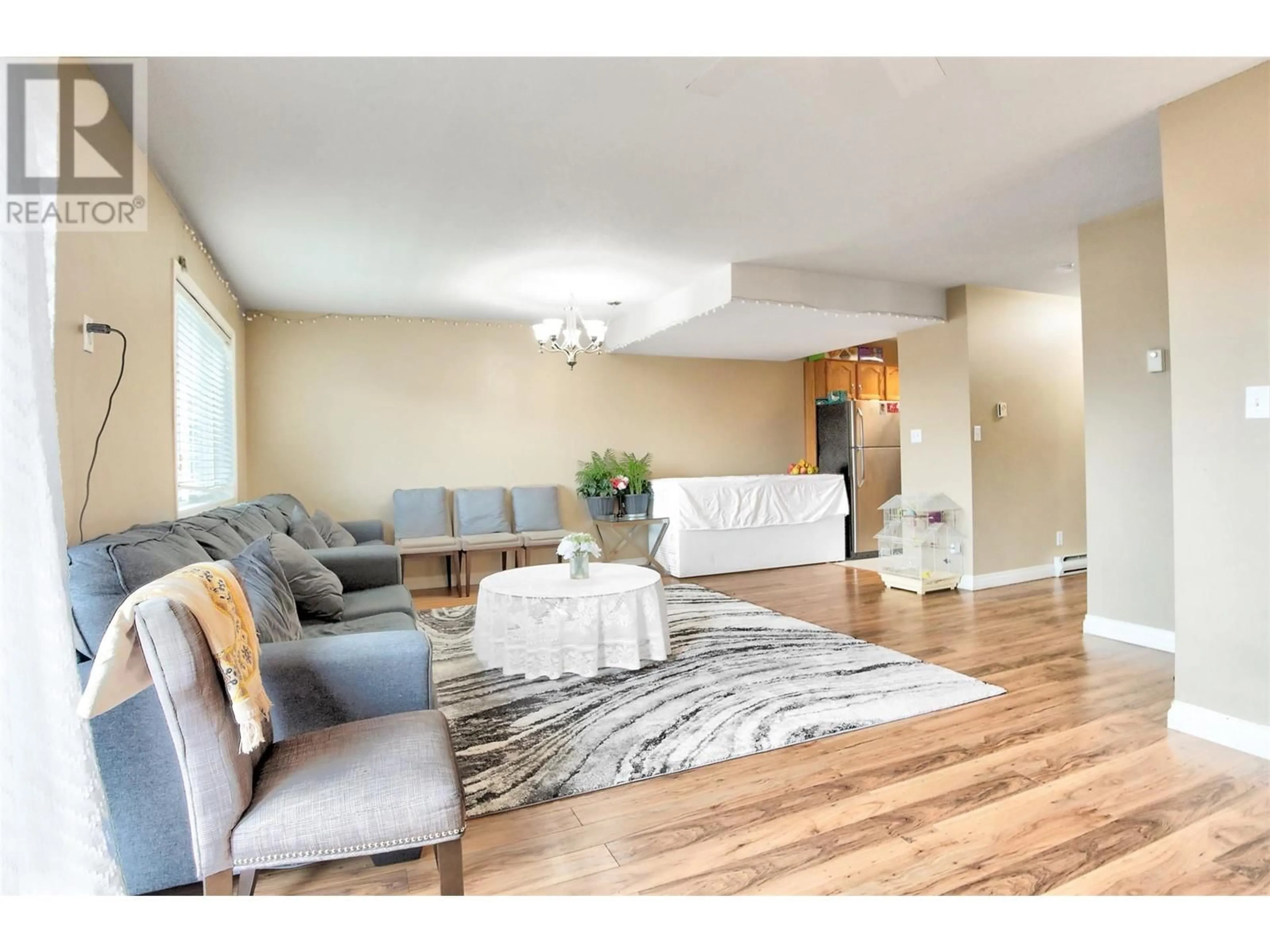 Living room with furniture, wood/laminate floor for 203 - 95 ECKHARDT AVENUE, Penticton British Columbia V2A8L2
