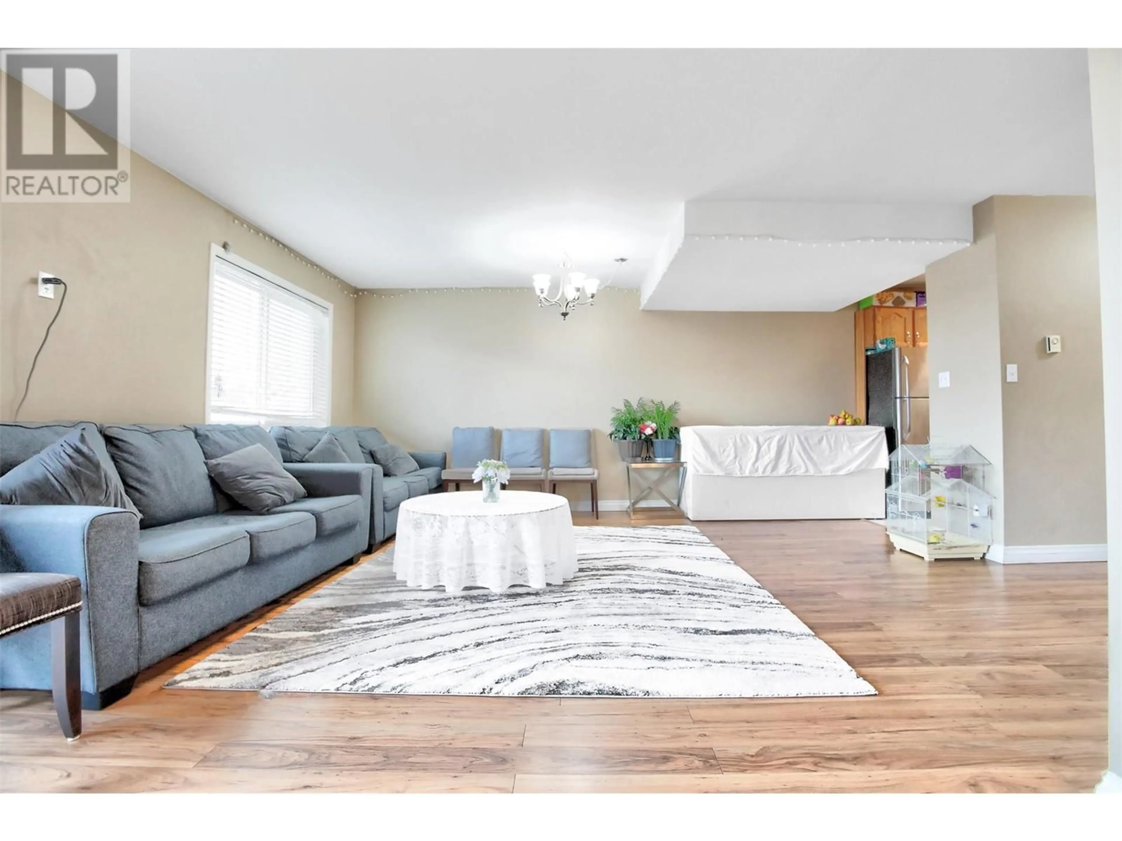 Living room with furniture, wood/laminate floor for 203 - 95 ECKHARDT AVENUE, Penticton British Columbia V2A8L2