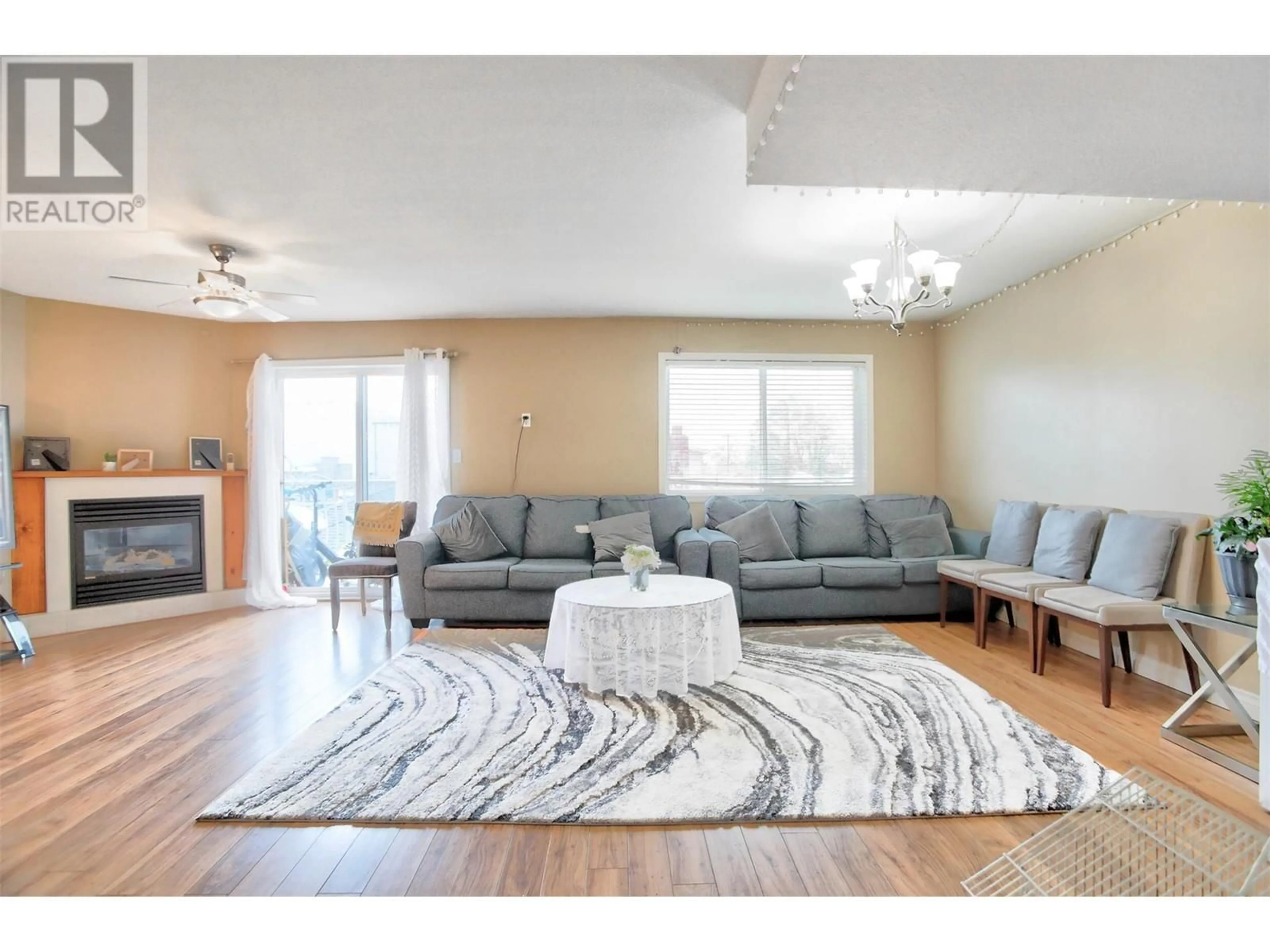 Living room with furniture, wood/laminate floor for 203 - 95 ECKHARDT AVENUE, Penticton British Columbia V2A8L2