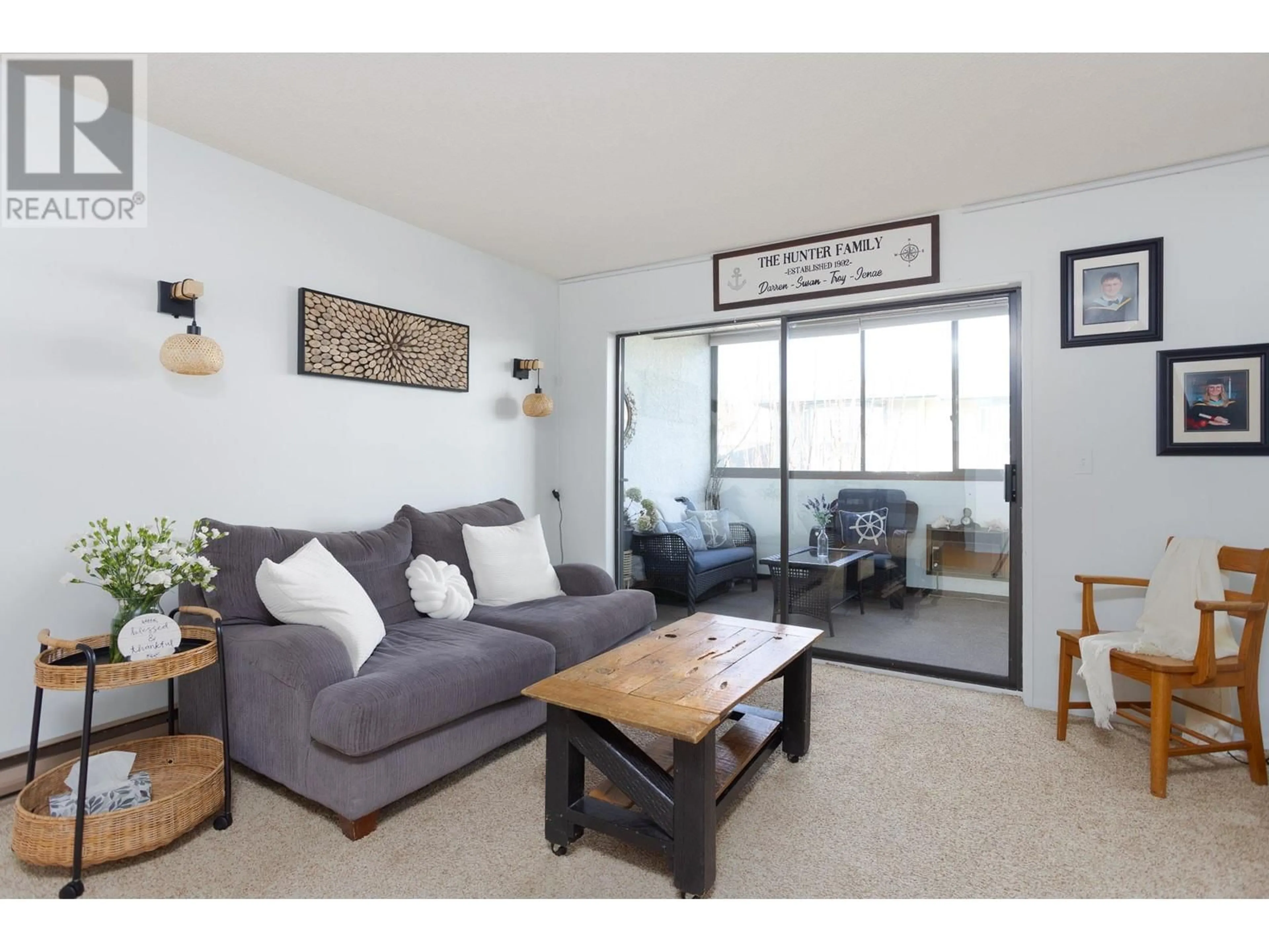 Living room with furniture, wood/laminate floor for 204 - 2085 GORDON DRIVE, Kelowna British Columbia V1Y8S1
