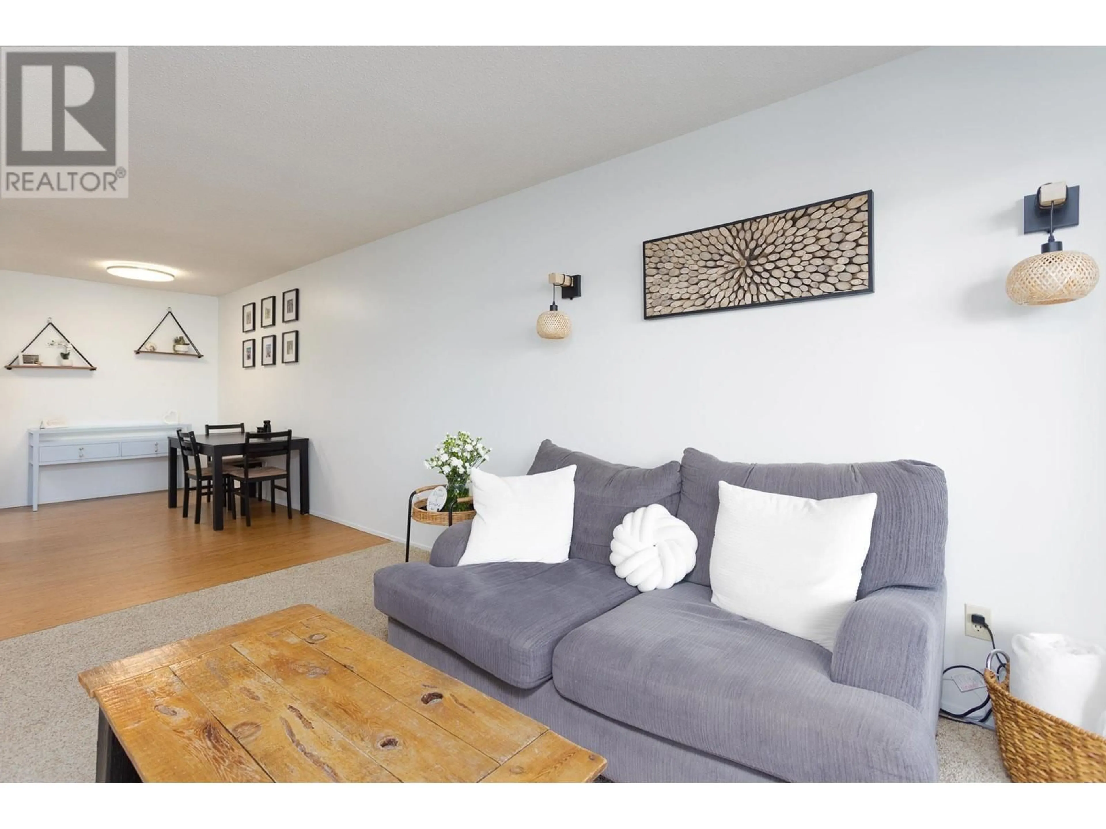 Living room with furniture, wood/laminate floor for 204 - 2085 GORDON DRIVE, Kelowna British Columbia V1Y8S1
