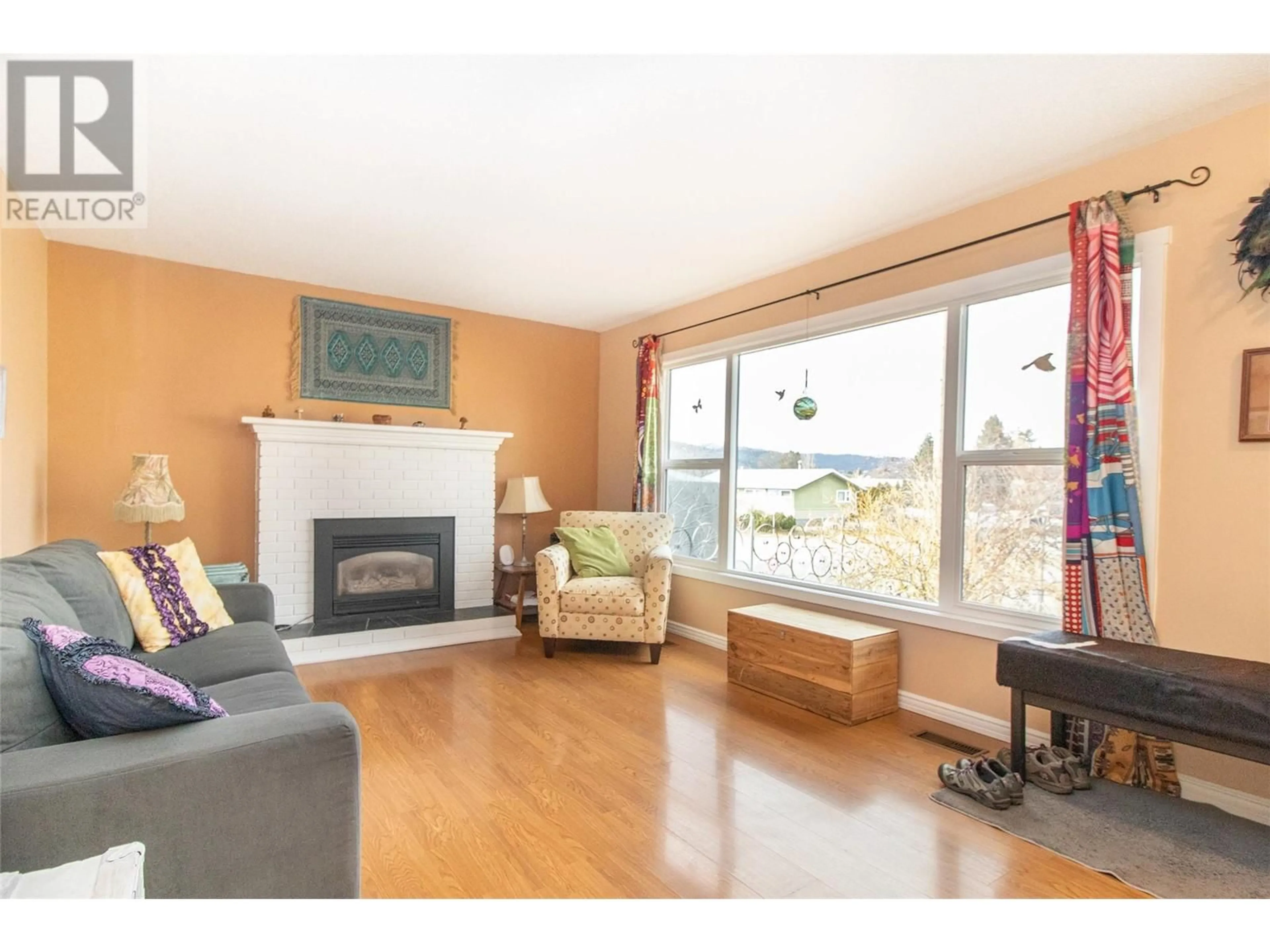 Living room with furniture, wood/laminate floor for 475 HOLLYDELL ROAD, Kelowna British Columbia V1X1L1