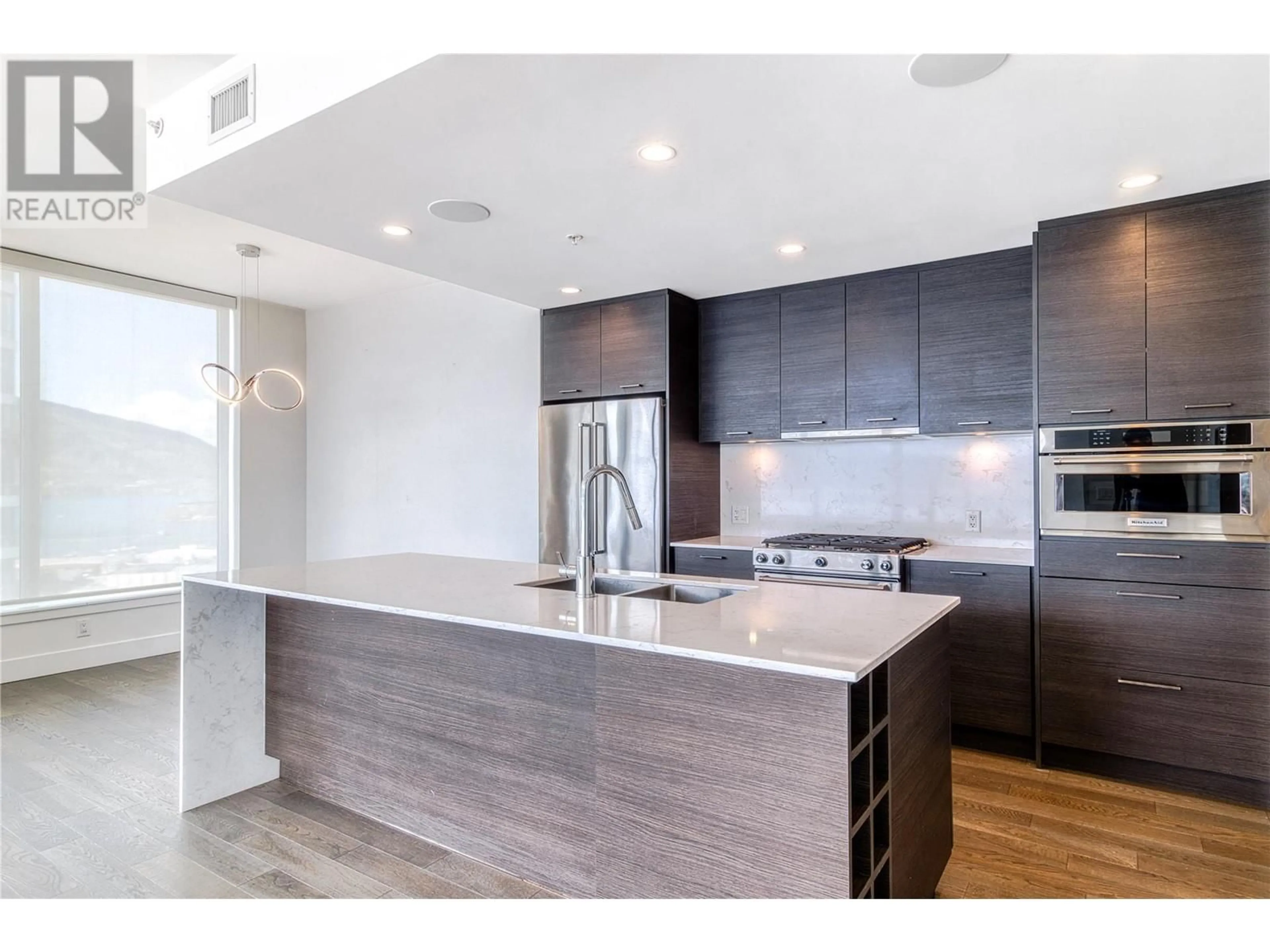 Open concept kitchen, wood/laminate floor for 2405 - 1191 SUNSET DRIVE, Kelowna British Columbia V1Y0J4