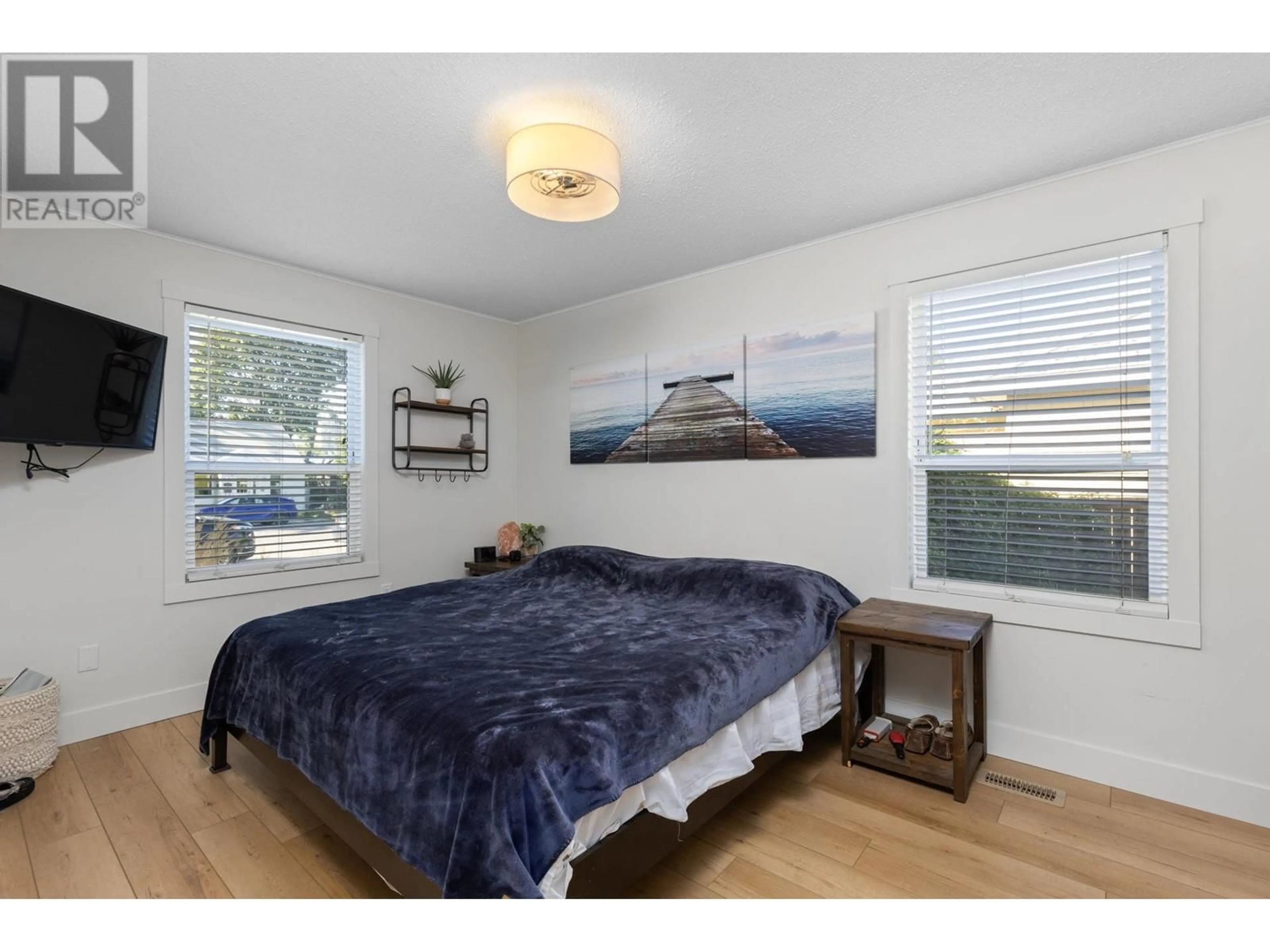 Bedroom with bed, wood/laminate floor for 566 OKANAGAN BOULEVARD, Kelowna British Columbia V1Y7L1
