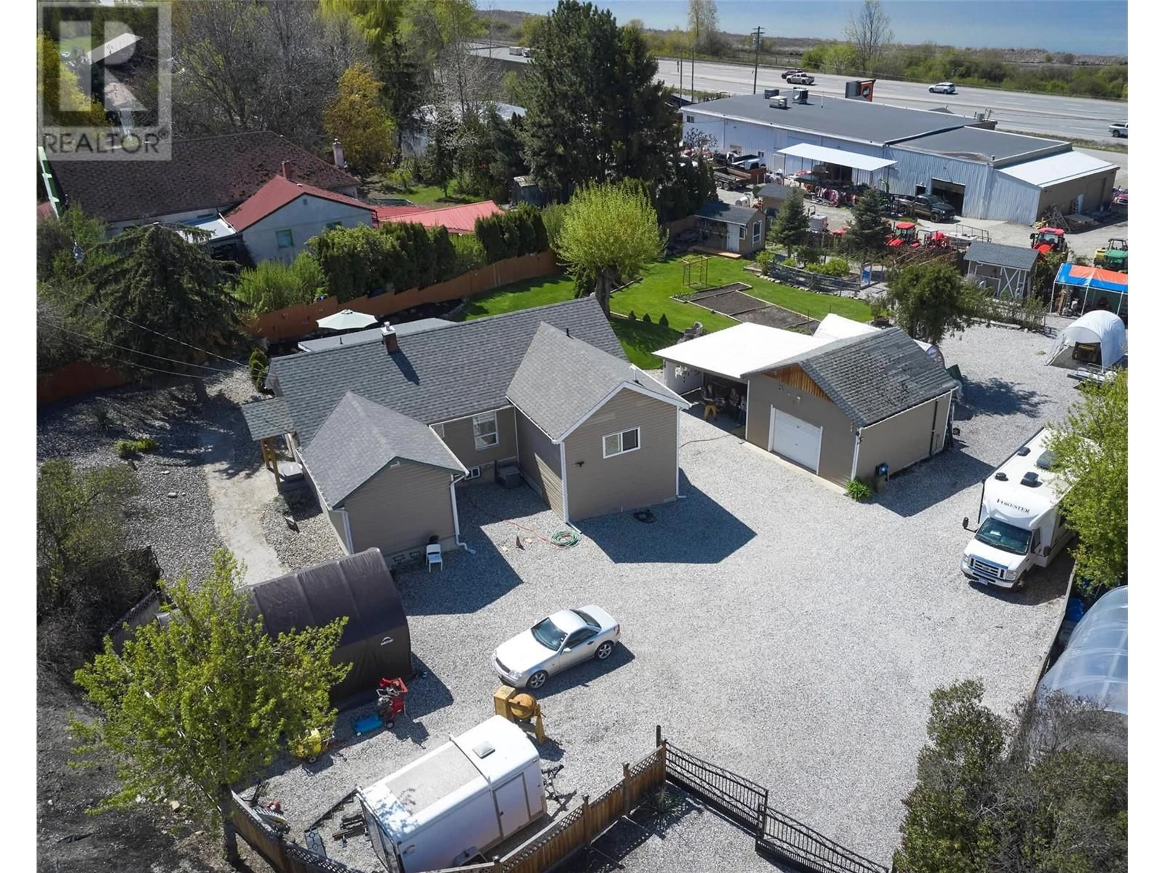 A pic from outside/outdoor area/front of a property/back of a property/a pic from drone, street for 7874 PLEASANT VALLEY ROAD, Vernon British Columbia V1B3R9