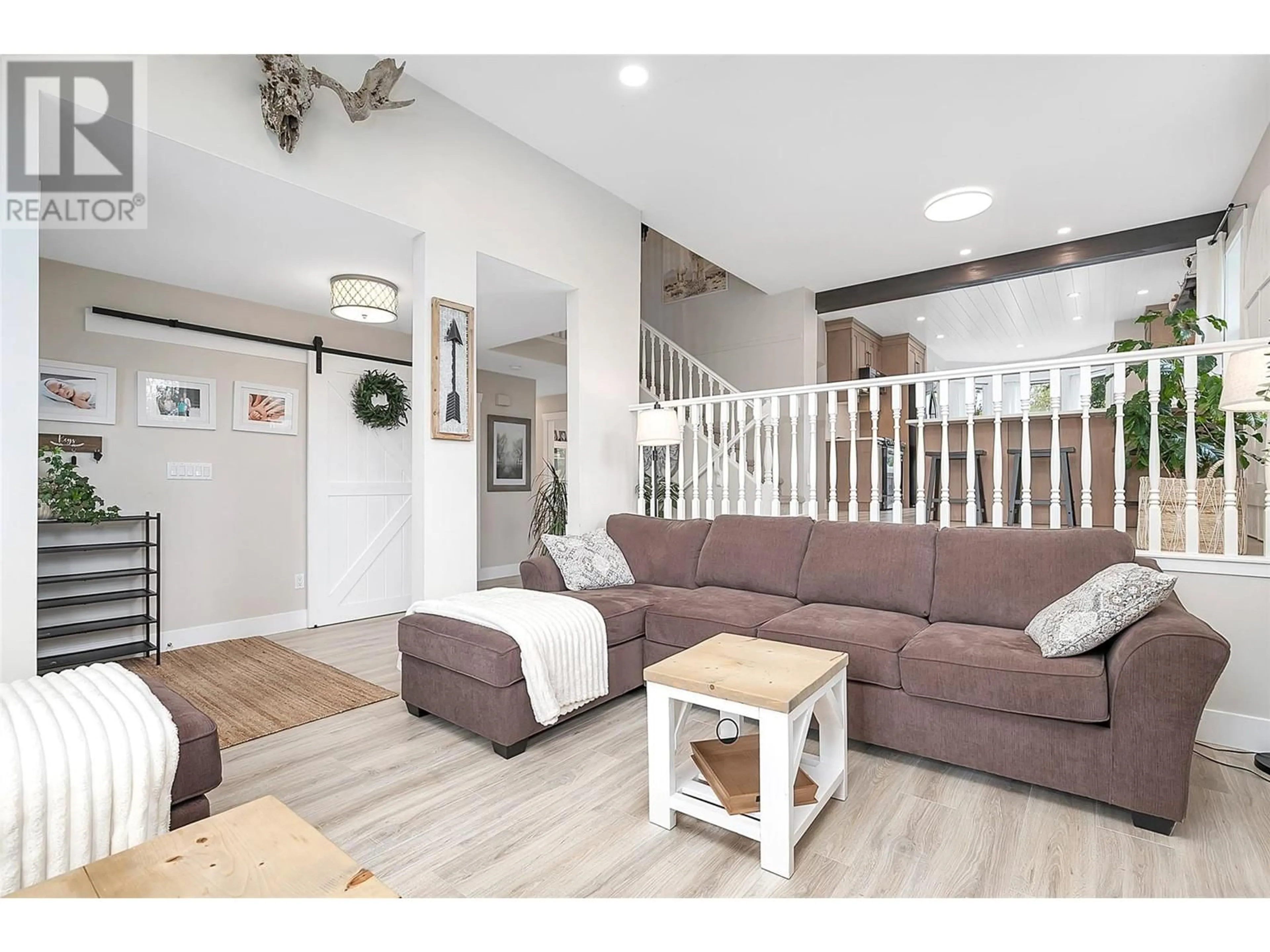 Living room with furniture, wood/laminate floor for 1859 KLONDIKE COURT, Lake Country British Columbia V4V1P2