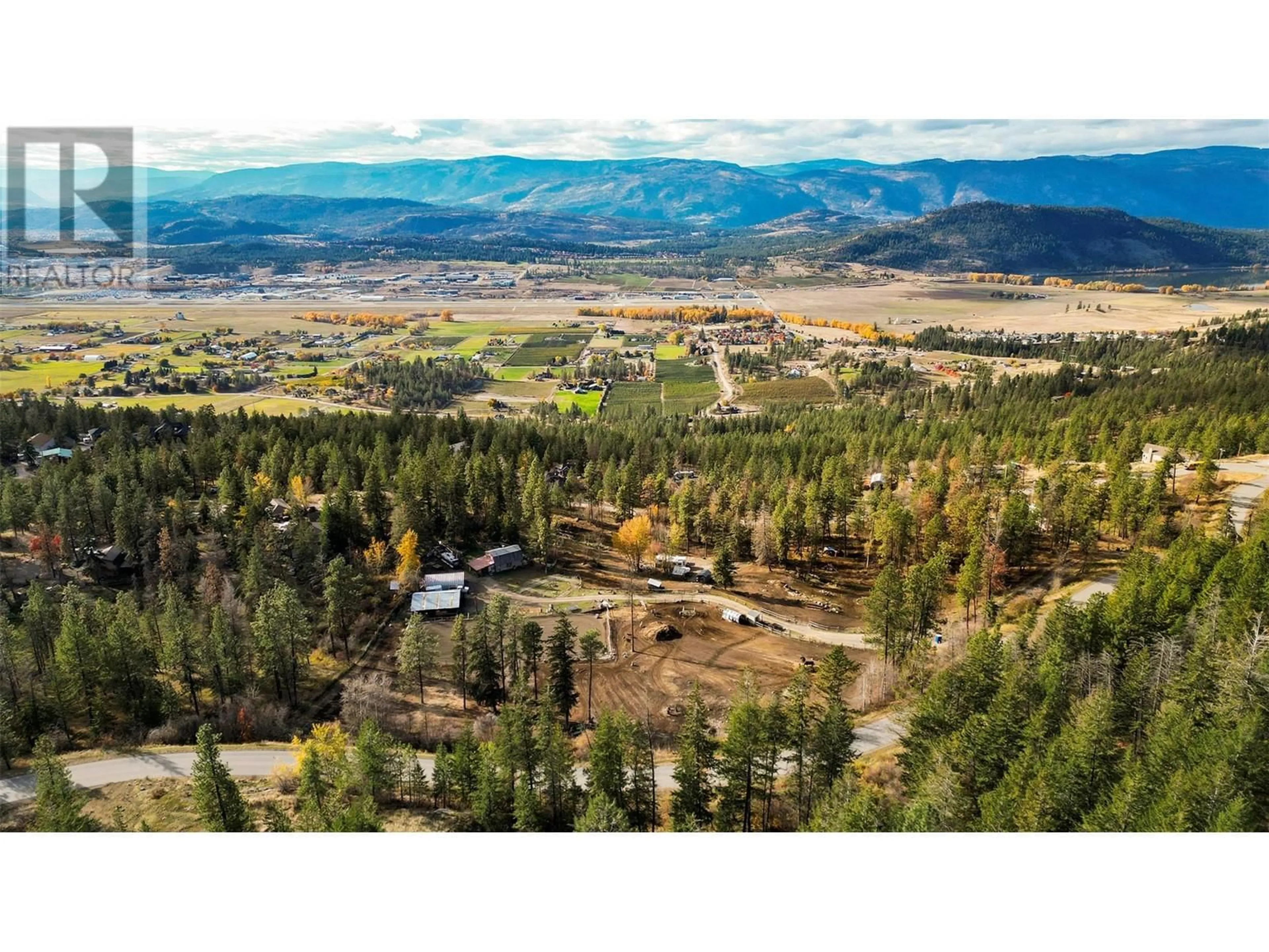 A pic from outside/outdoor area/front of a property/back of a property/a pic from drone, mountain view for 5974 FARMERS DRIVE, Kelowna British Columbia V1P1A3