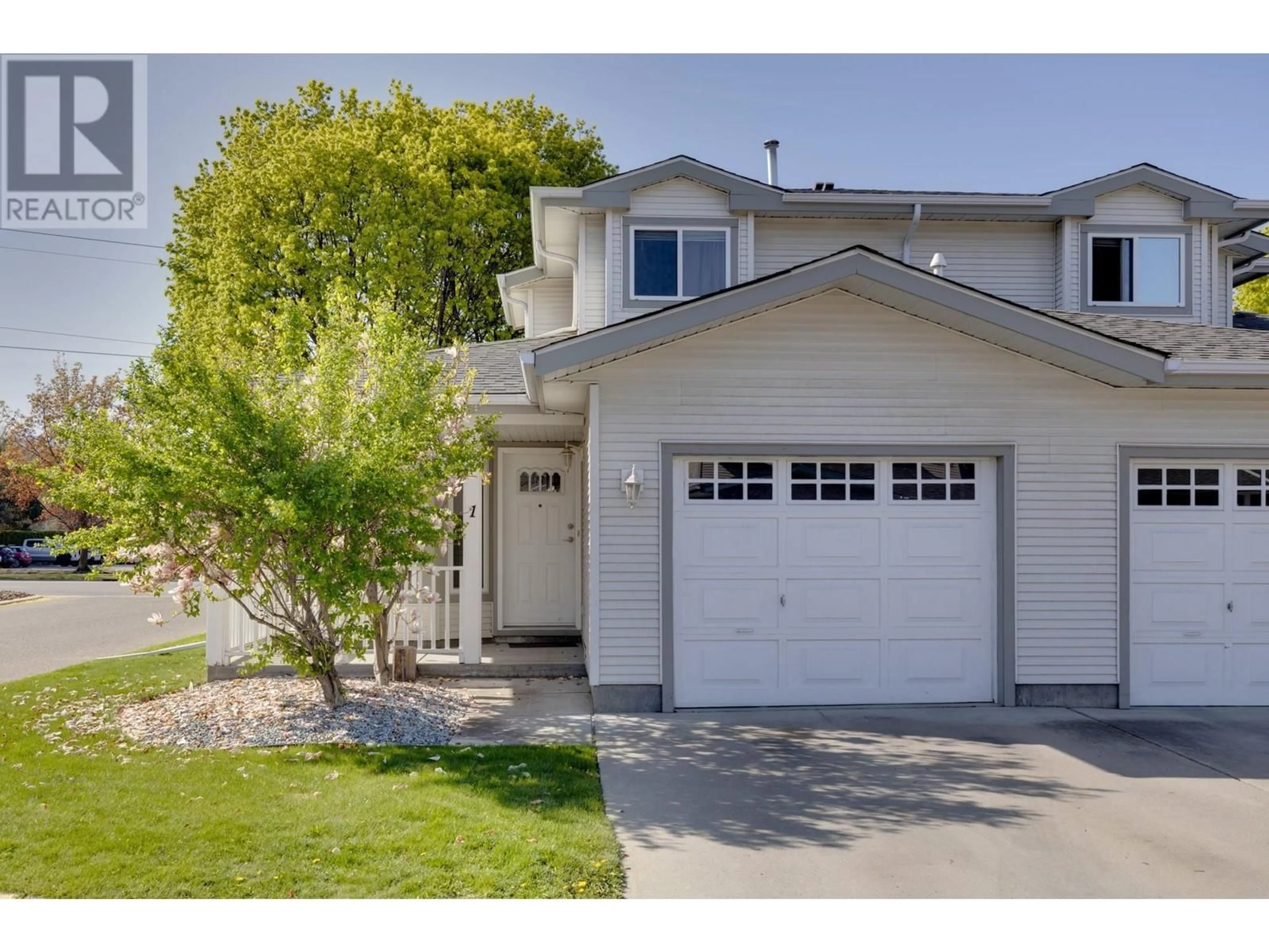 Home with vinyl exterior material, street for 1 - 1120 GUISACHAN ROAD, Kelowna British Columbia V1Y9R5