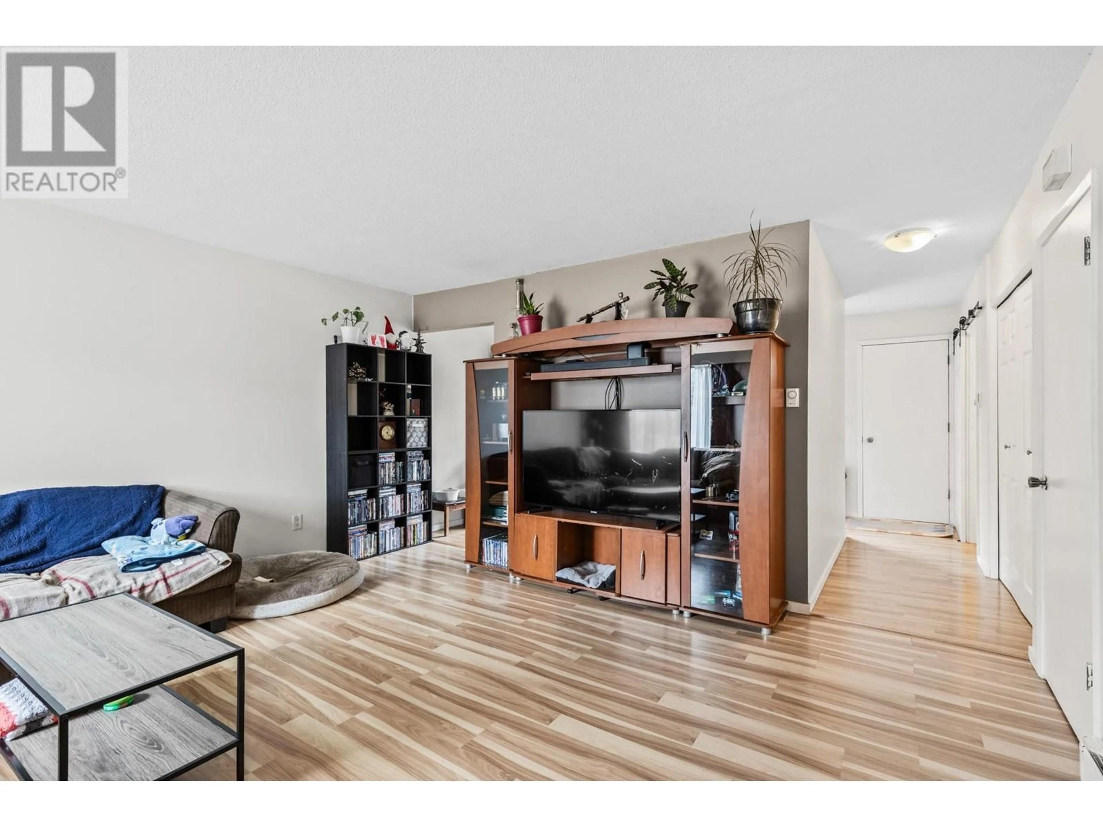 Living room with furniture, wood/laminate floor for 690 BELL ROAD, Kelowna British Columbia V1X2Y1