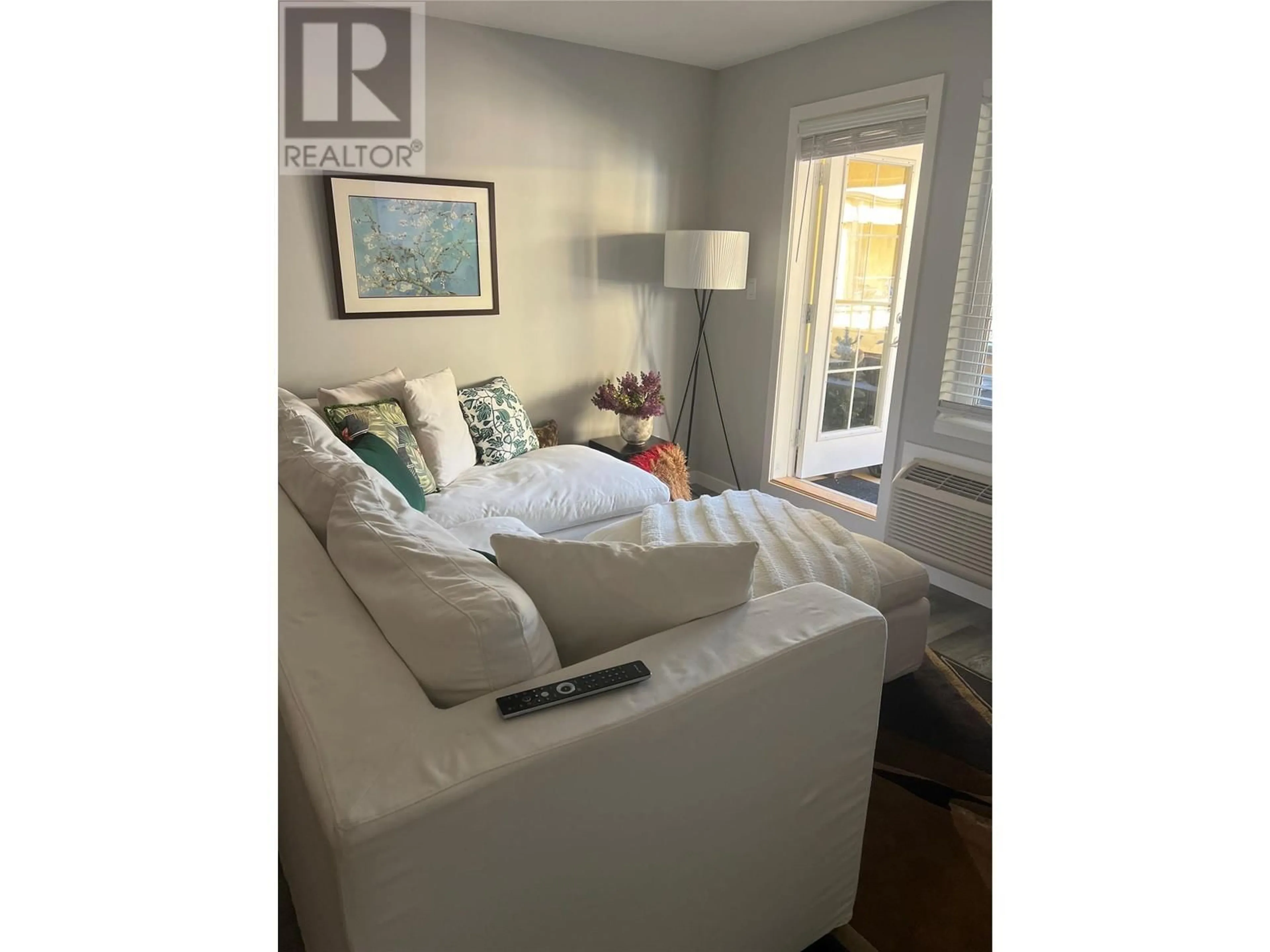 Living room with furniture, wood/laminate floor for 315 - 7600 COTTONWOOD DRIVE, Osoyoos British Columbia V0H1V3