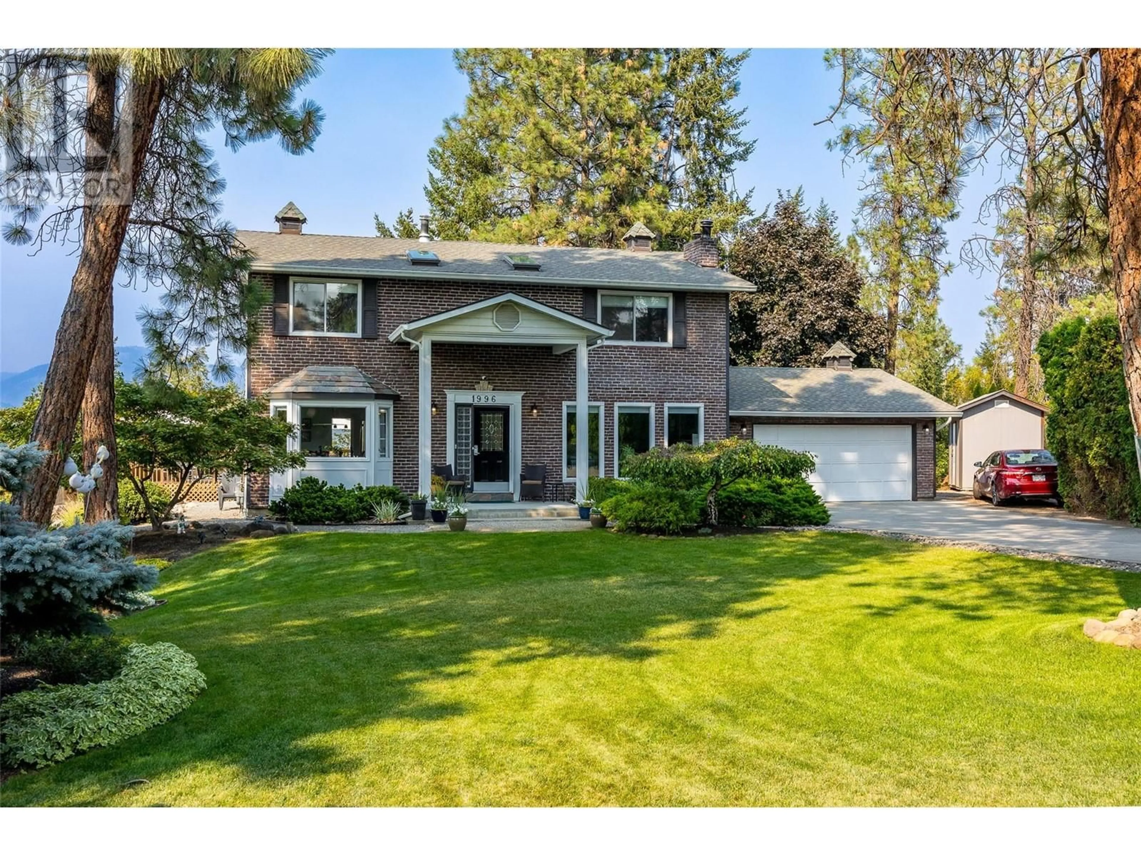 Home with vinyl exterior material, street for 1996 TOMAT AVENUE, Kelowna British Columbia V1Z3C5