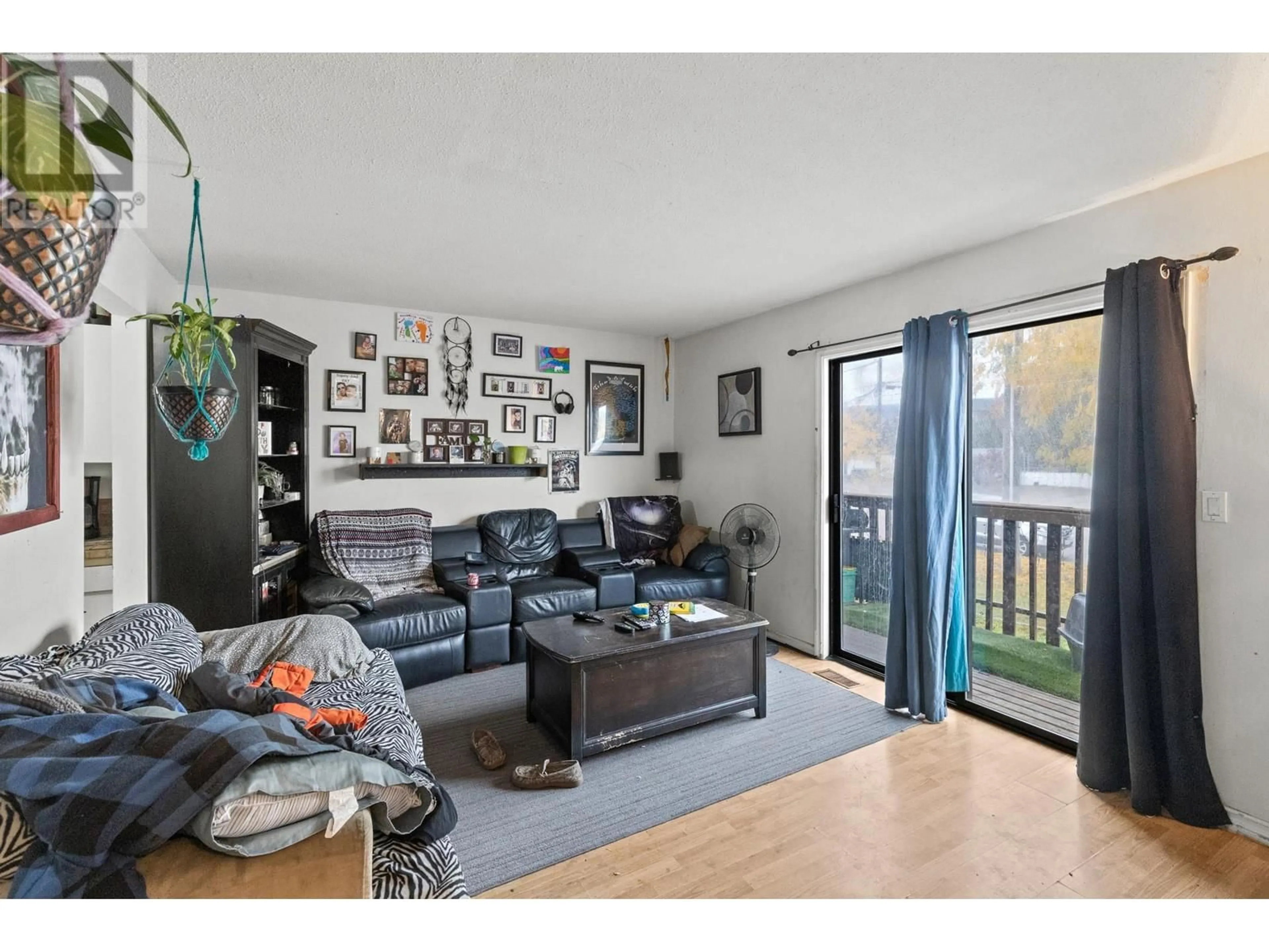 Living room with furniture, wood/laminate floor for 490D HEIN ROAD, Kelowna British Columbia V1X4A3