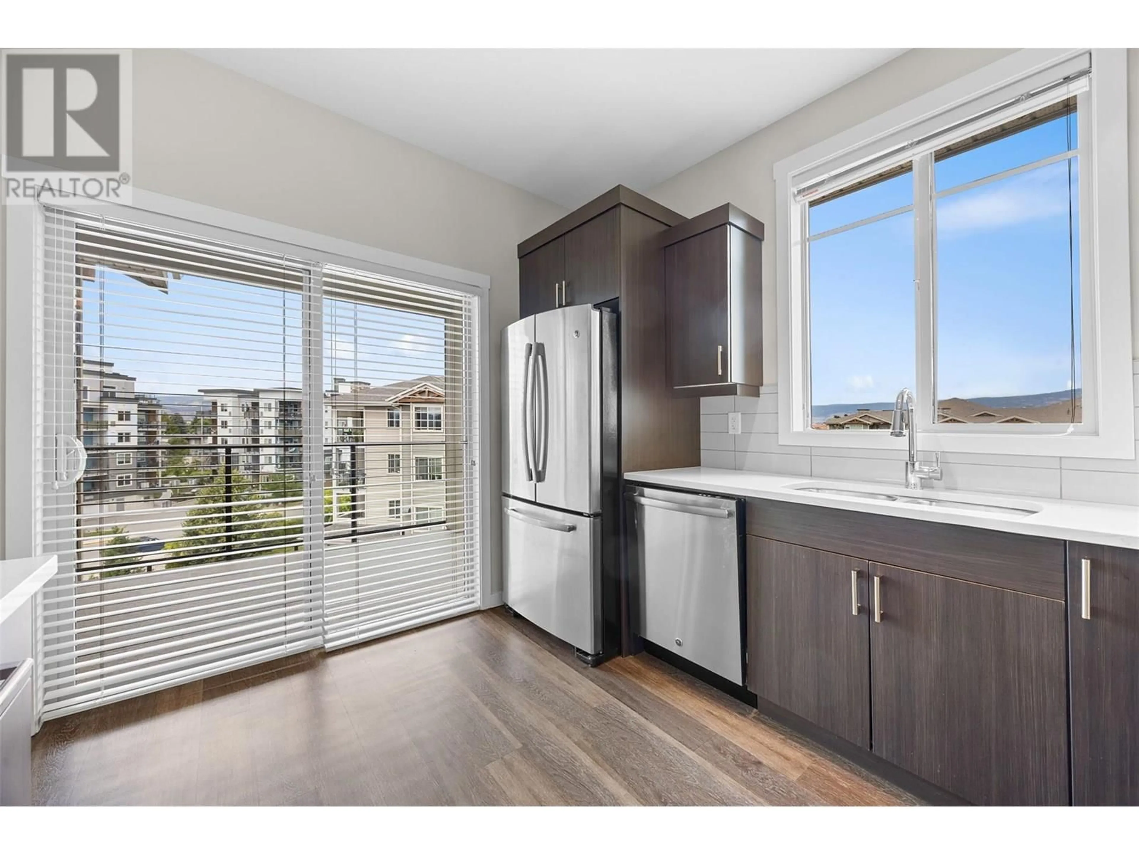 Open concept kitchen, wood/laminate floor for 412 - 3731 CASORSO ROAD, Kelowna British Columbia V1W5E9
