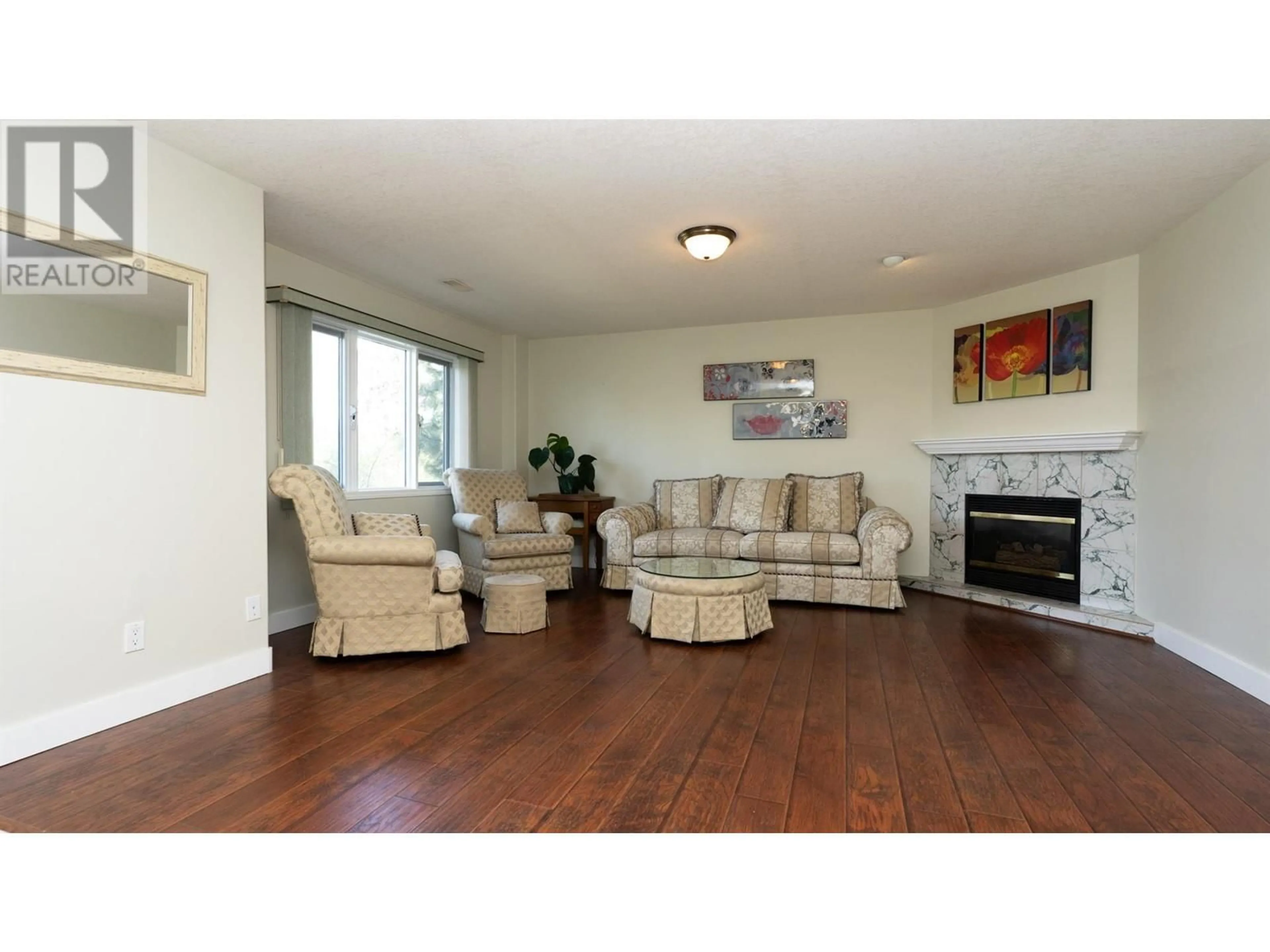 Living room with furniture, wood/laminate floor for 9085 TRONSON ROAD, Vernon British Columbia V1H1E2