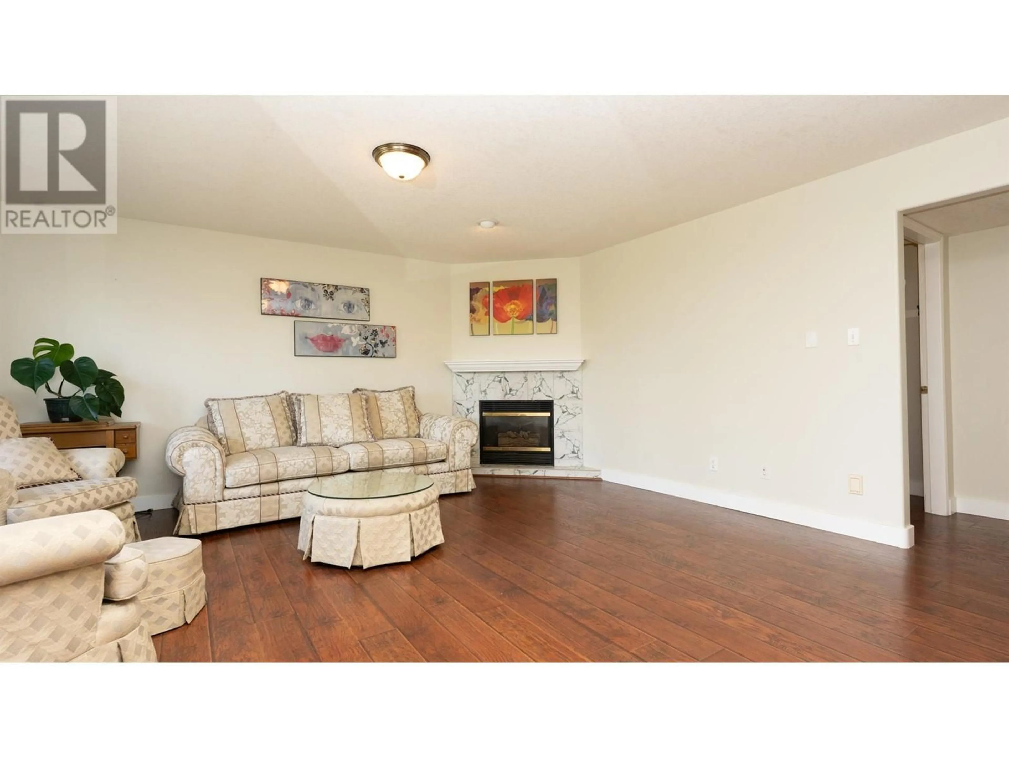 Living room with furniture, wood/laminate floor for 9085 TRONSON ROAD, Vernon British Columbia V1H1E2