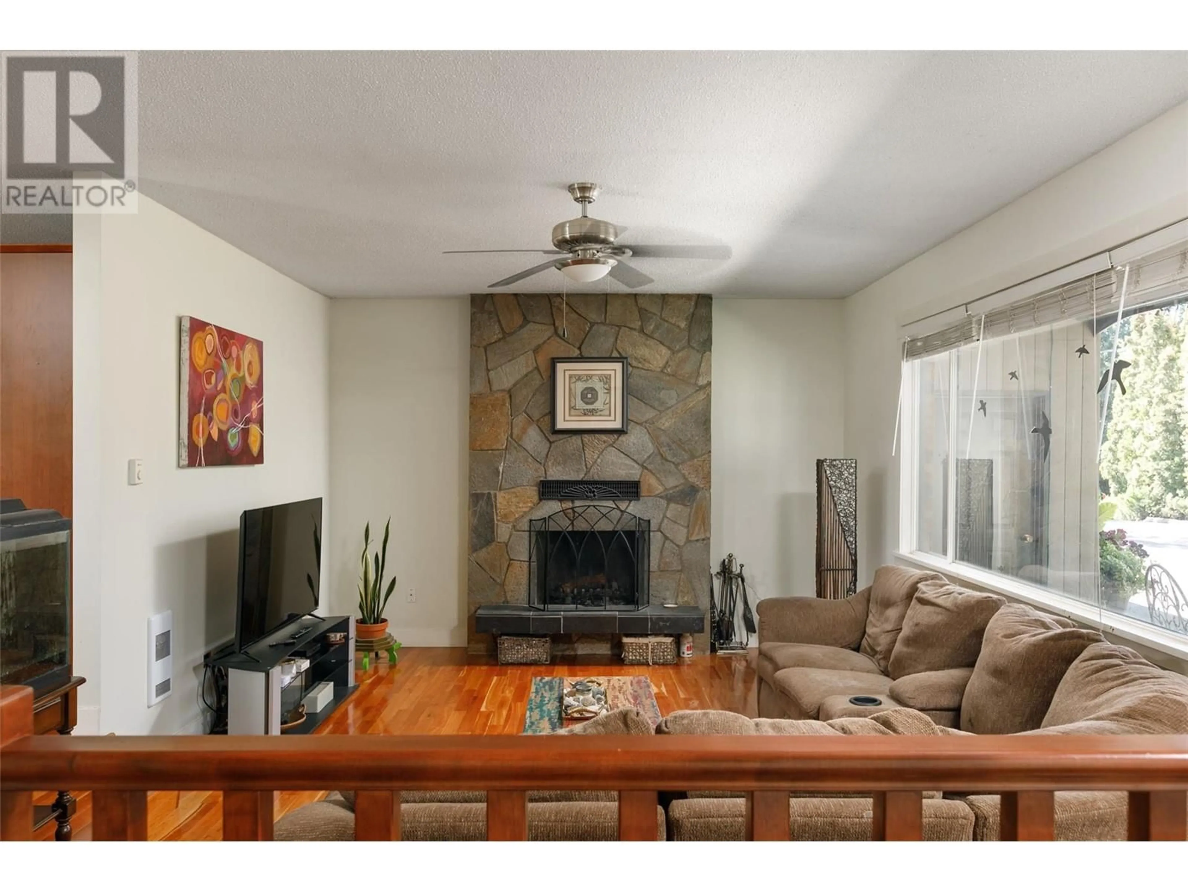 Living room with furniture, wood/laminate floor for 2351 GALLAGHER ROAD, Kelowna British Columbia V1P1G9