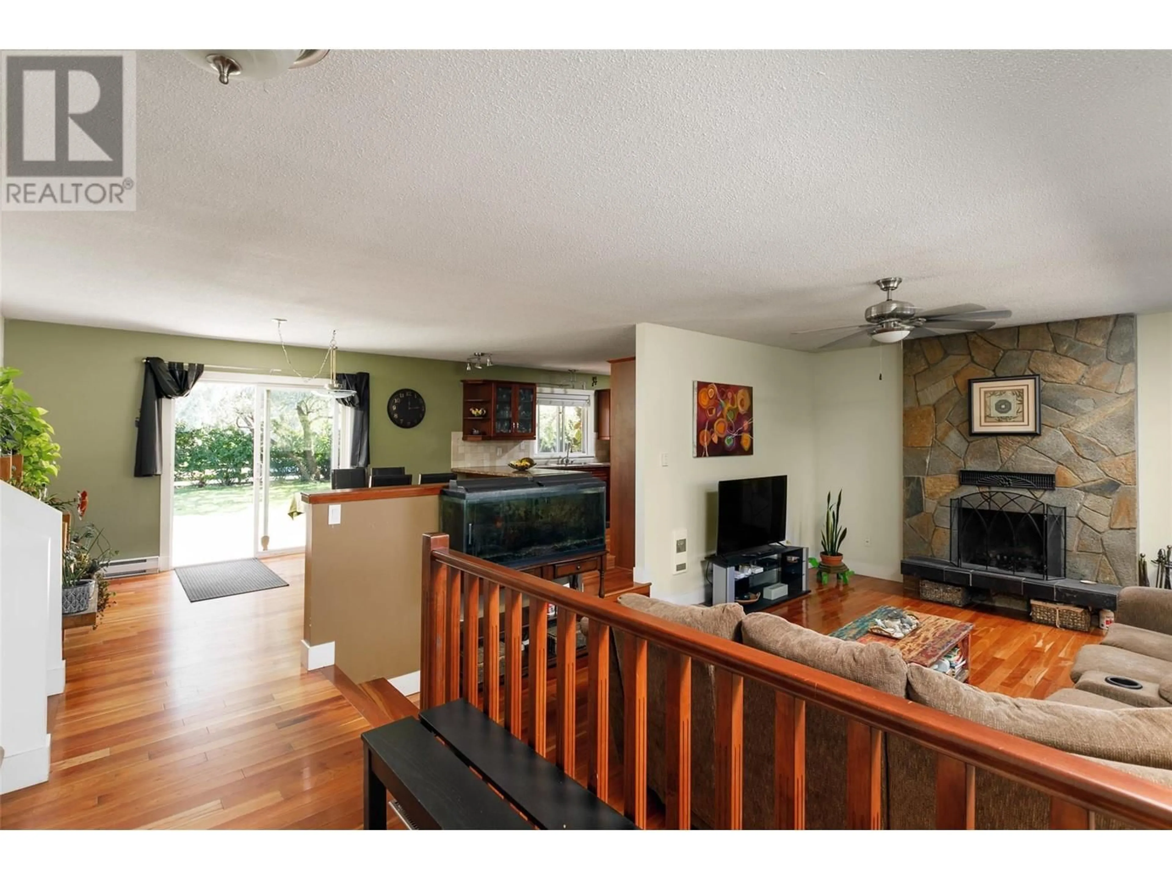 Living room with furniture, wood/laminate floor for 2351 GALLAGHER ROAD, Kelowna British Columbia V1P1G9
