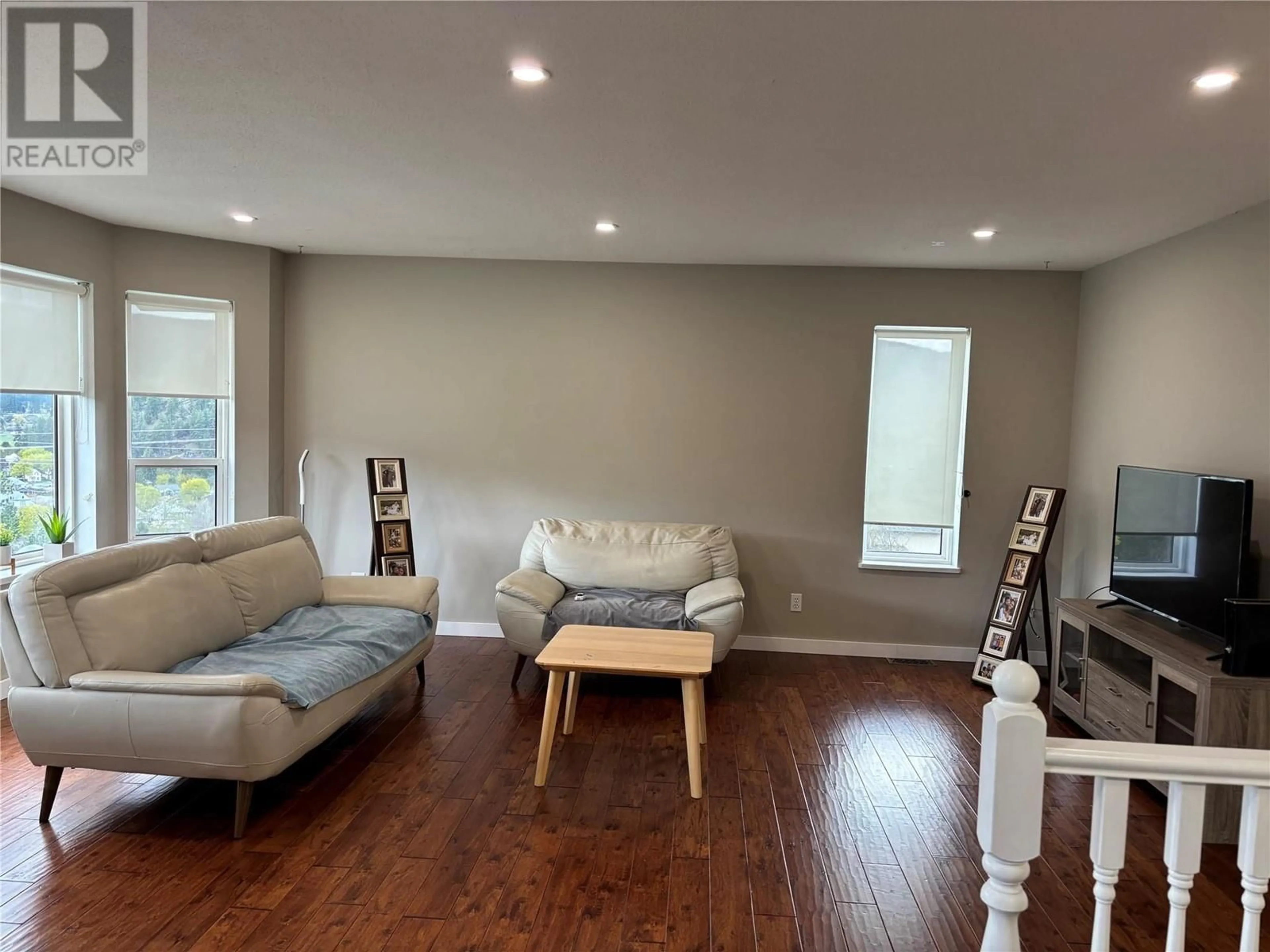 Living room with furniture, wood/laminate floor for 7415 VALLEY HEIGHTS DRIVE, Grand Forks British Columbia V0H1H0