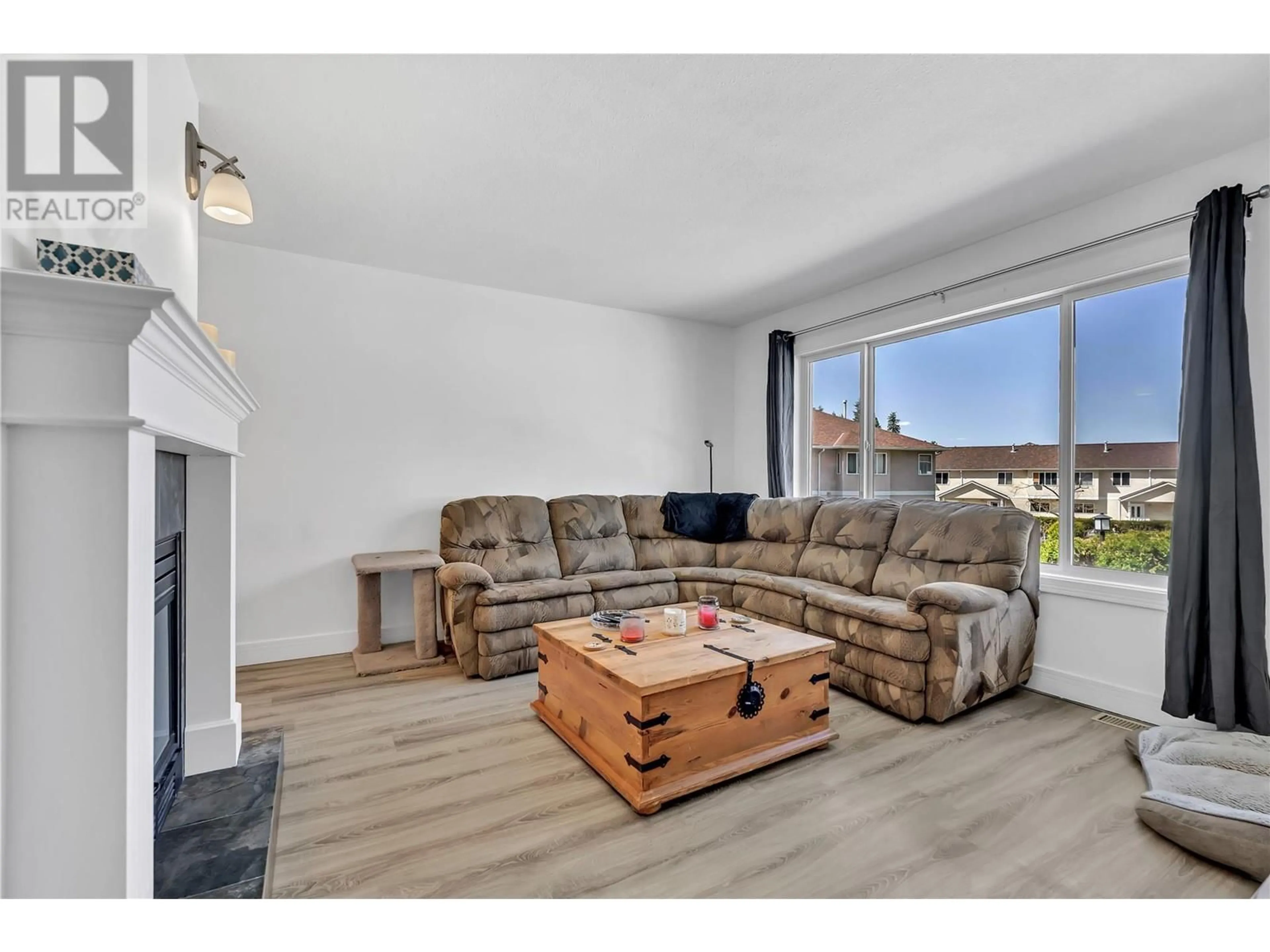 Living room with furniture, wood/laminate floor for 115 - 1458 PENTICTON AVENUE, Penticton British Columbia V2A8L3