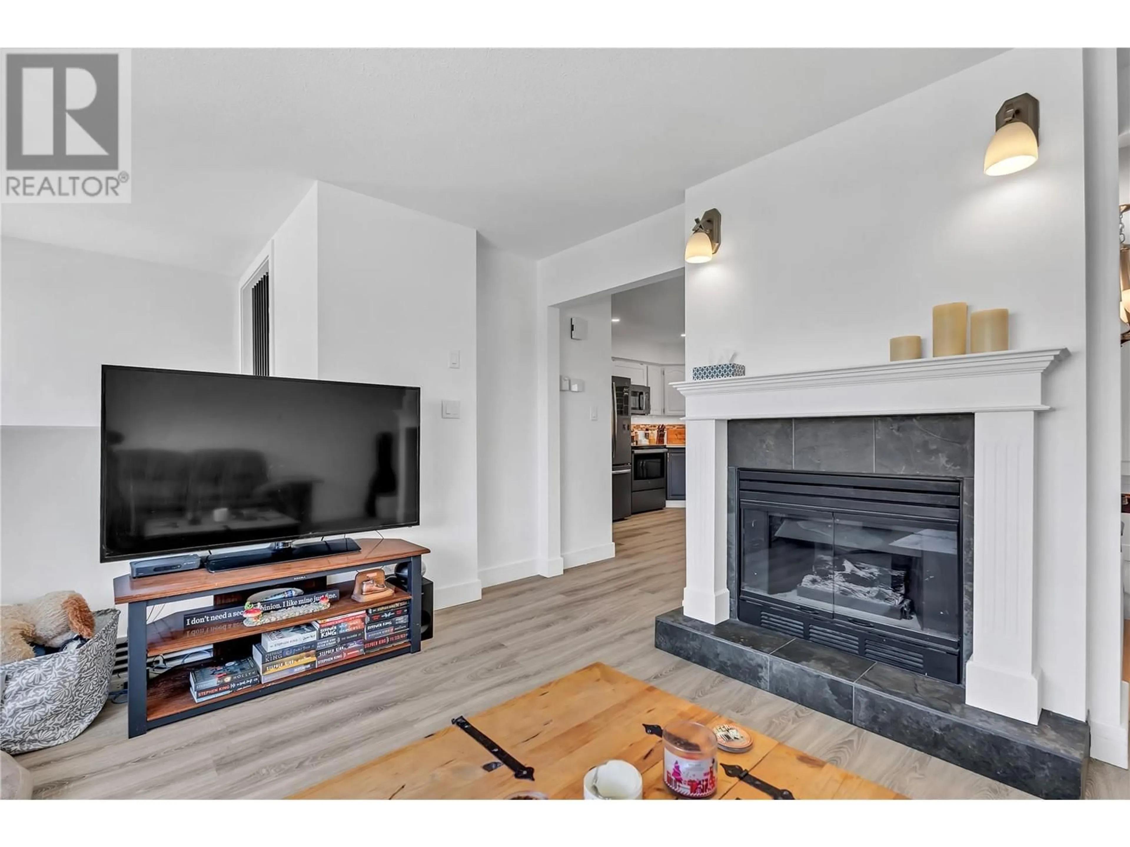 Living room with furniture, wood/laminate floor for 115 - 1458 PENTICTON AVENUE, Penticton British Columbia V2A8L3