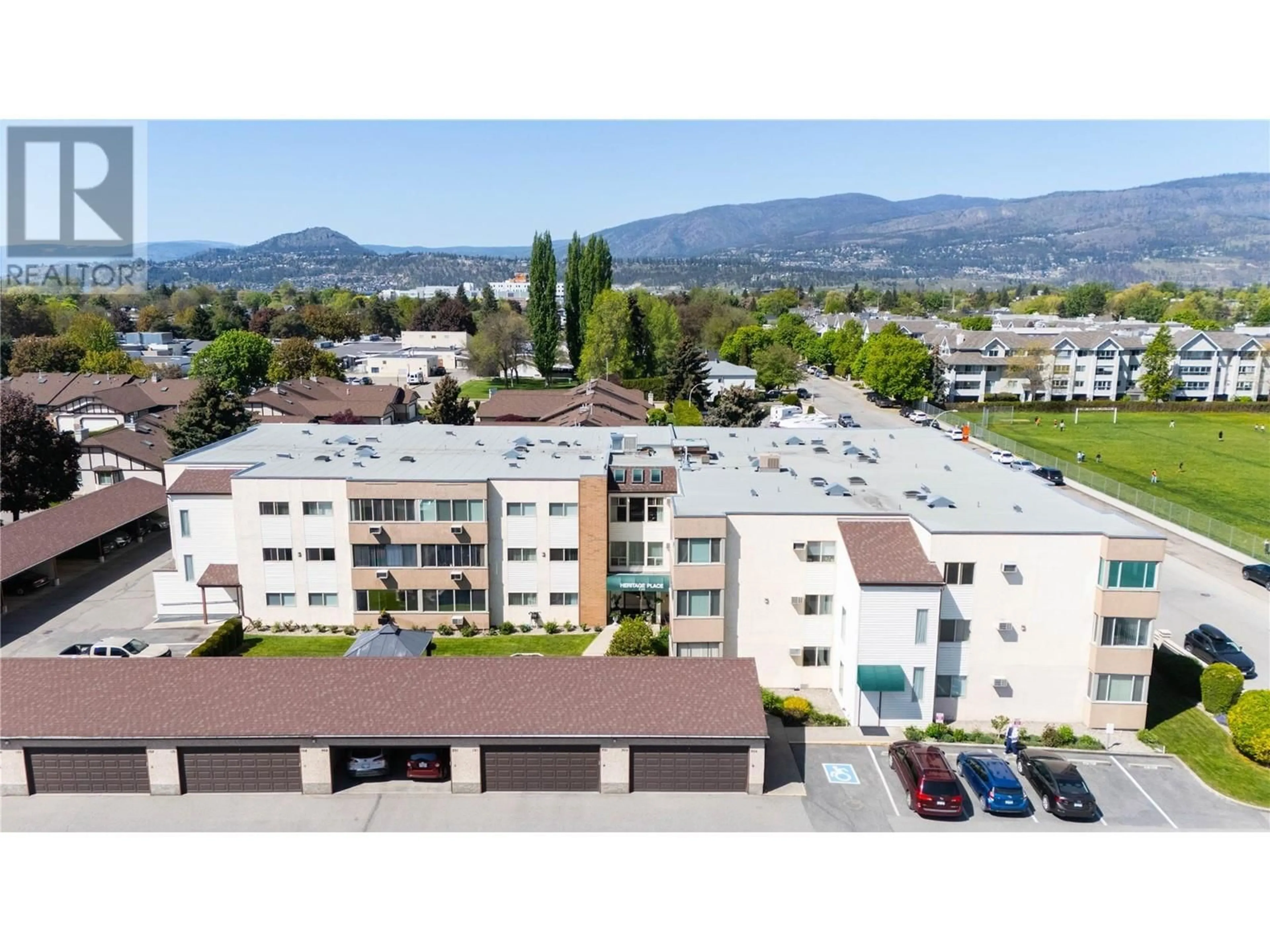 A pic from outside/outdoor area/front of a property/back of a property/a pic from drone, mountain view for 208 - 1055 GLENWOOD AVENUE, Kelowna British Columbia V1Y5M8