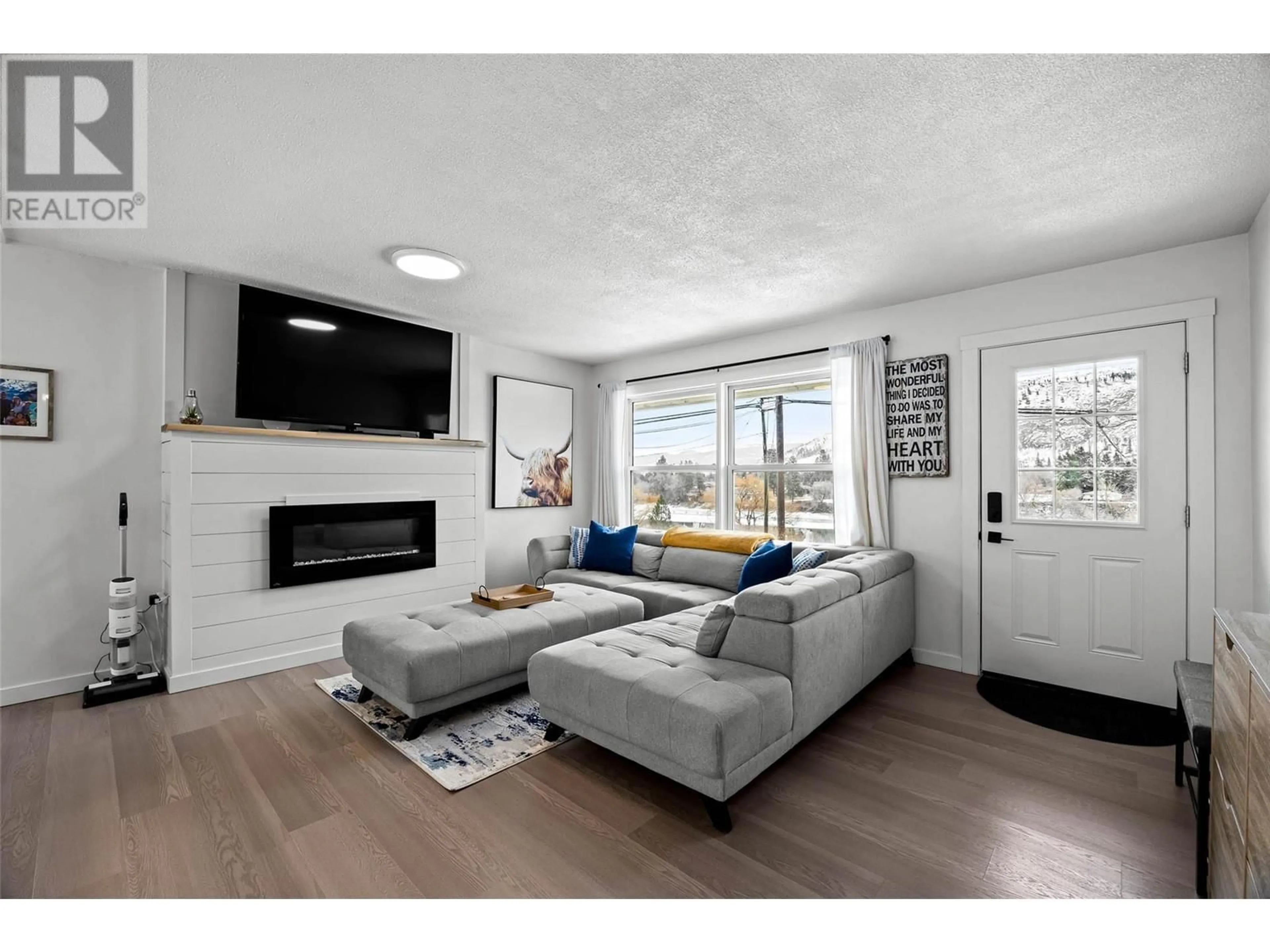 Living room with furniture, wood/laminate floor for 4396 WESTSYDE ROAD, Kamloops British Columbia V2B8N2