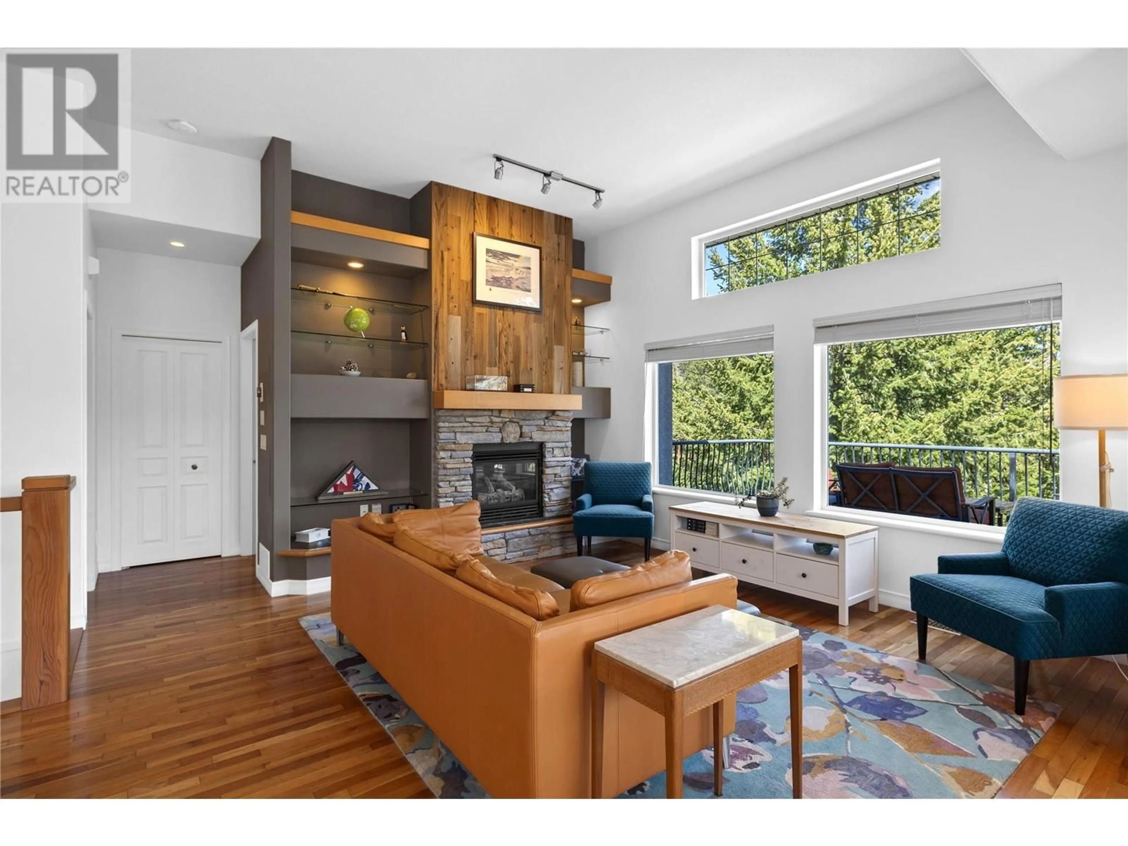 Living room with furniture, wood/laminate floor for 103 - 1950 CAPISTRANO DRIVE, Kelowna British Columbia V1V2N7