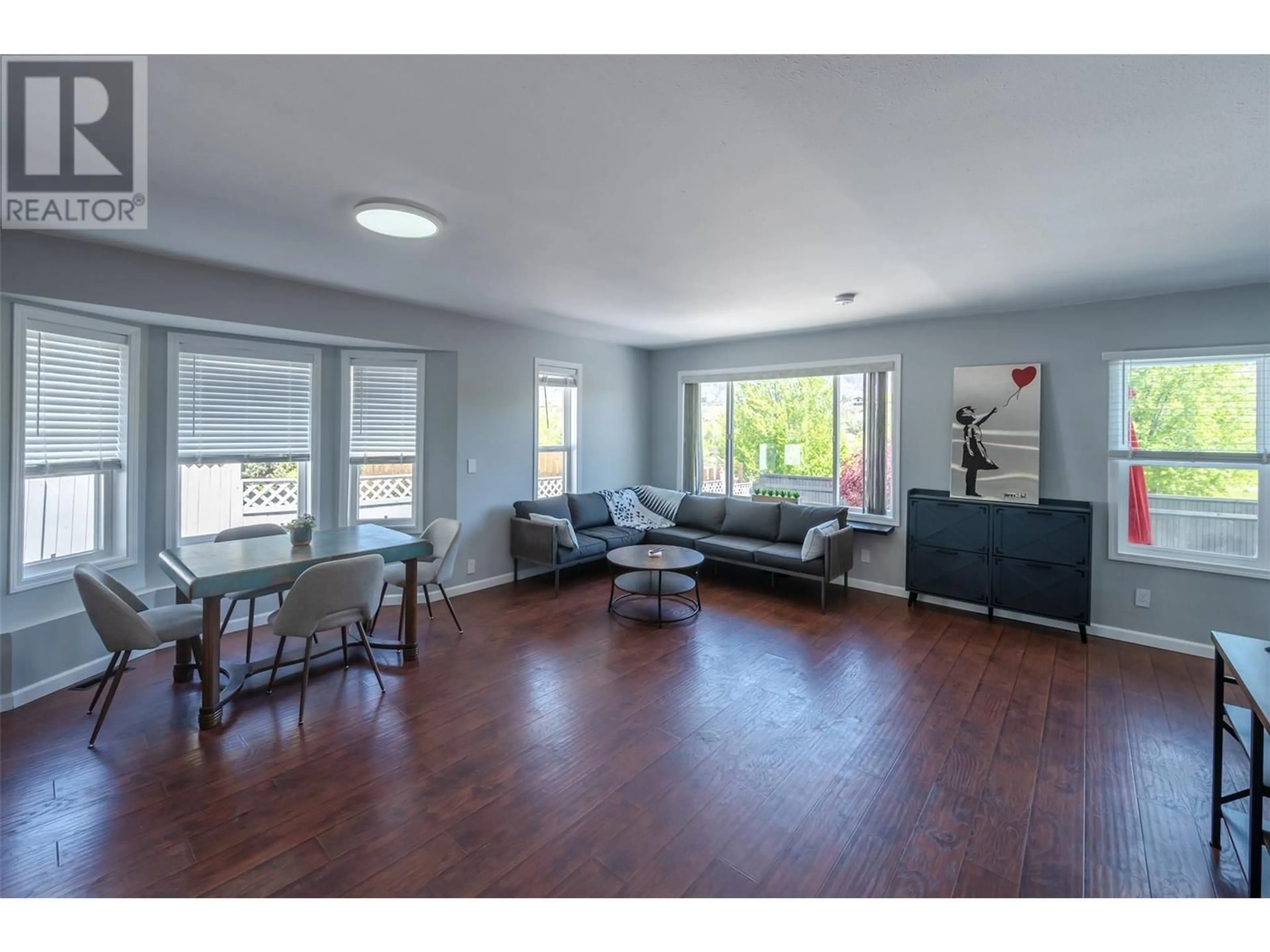 Living room with furniture, wood/laminate floor for 6548 MAIN STREET, Oliver British Columbia V0H1T0