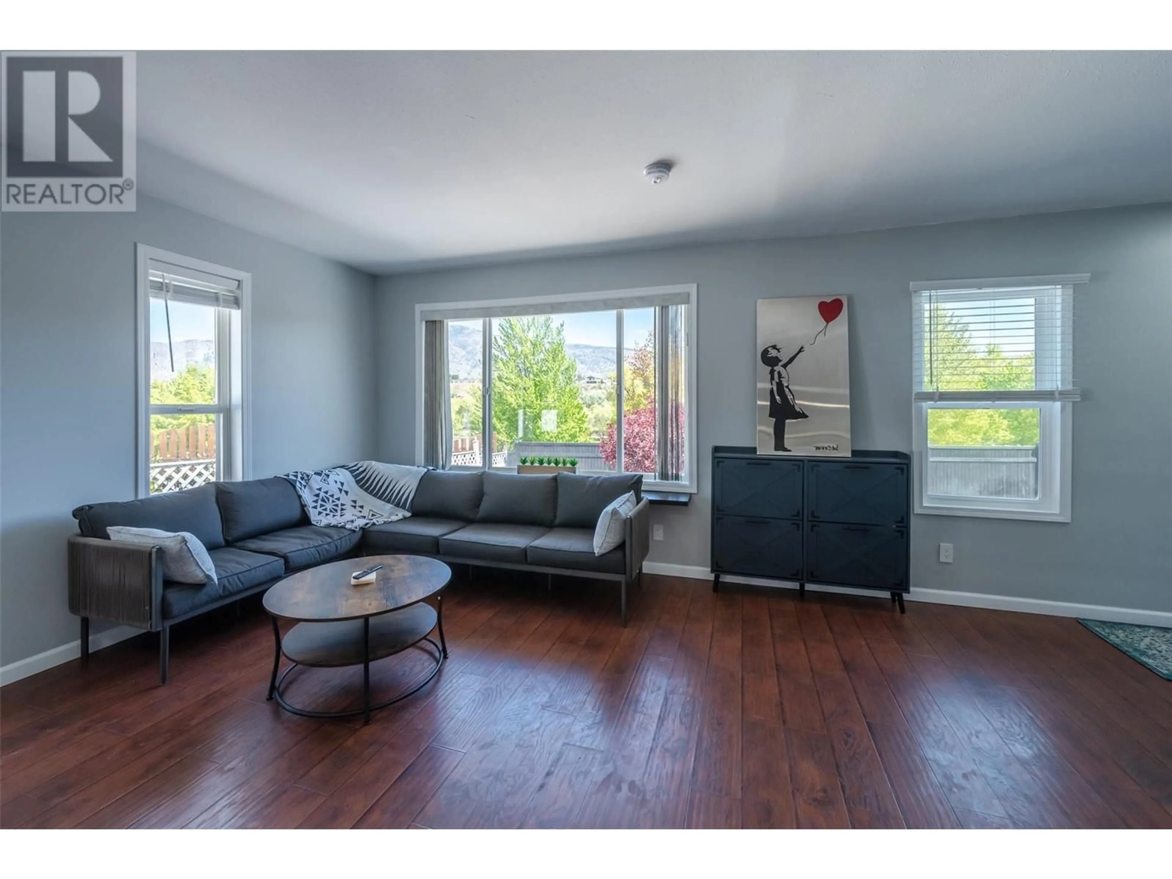 Living room with furniture, wood/laminate floor for 6548 MAIN STREET, Oliver British Columbia V0H1T0