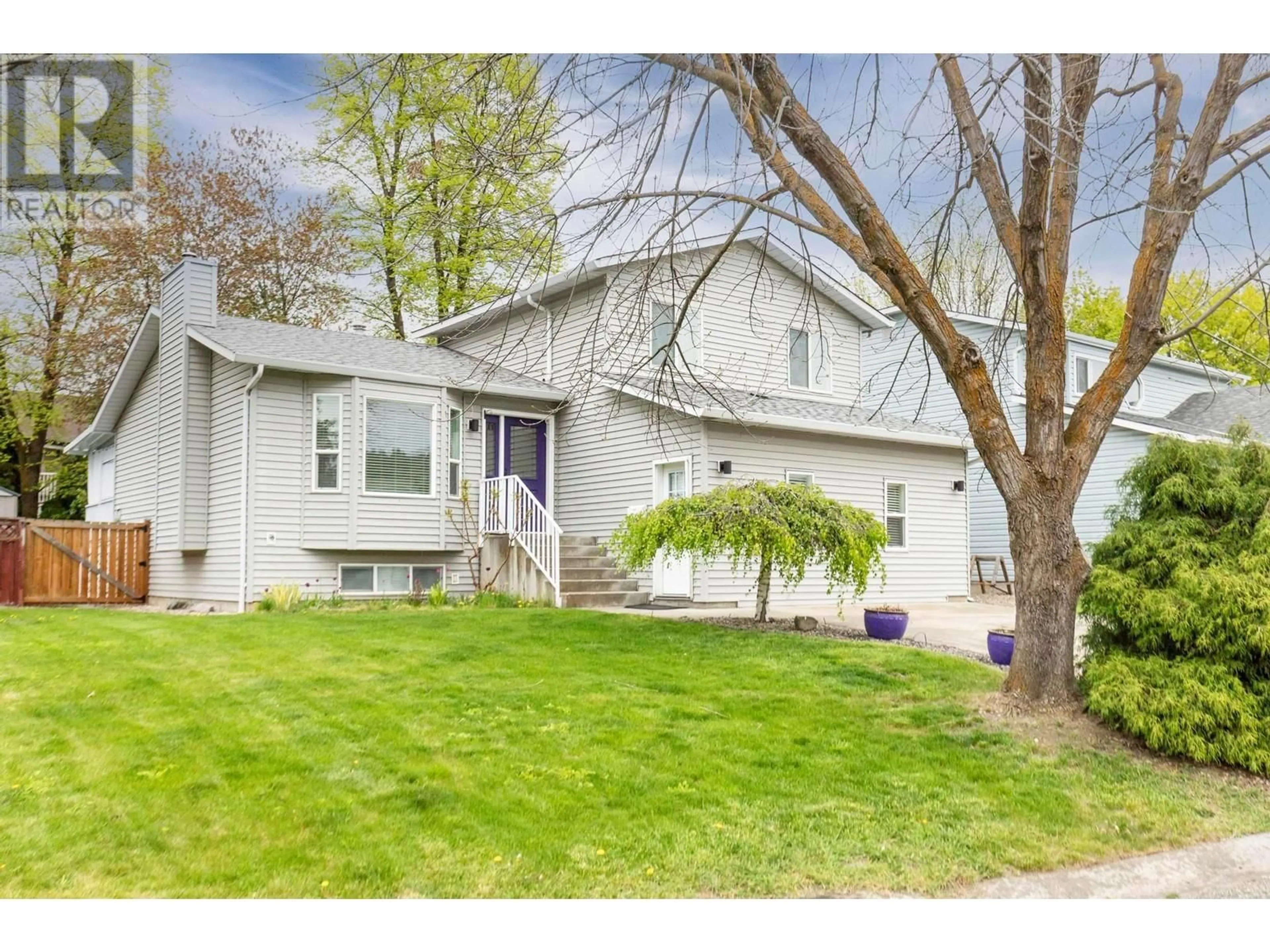 Home with vinyl exterior material, street for 2049 ASTER ROAD, Kelowna British Columbia V1V1P4