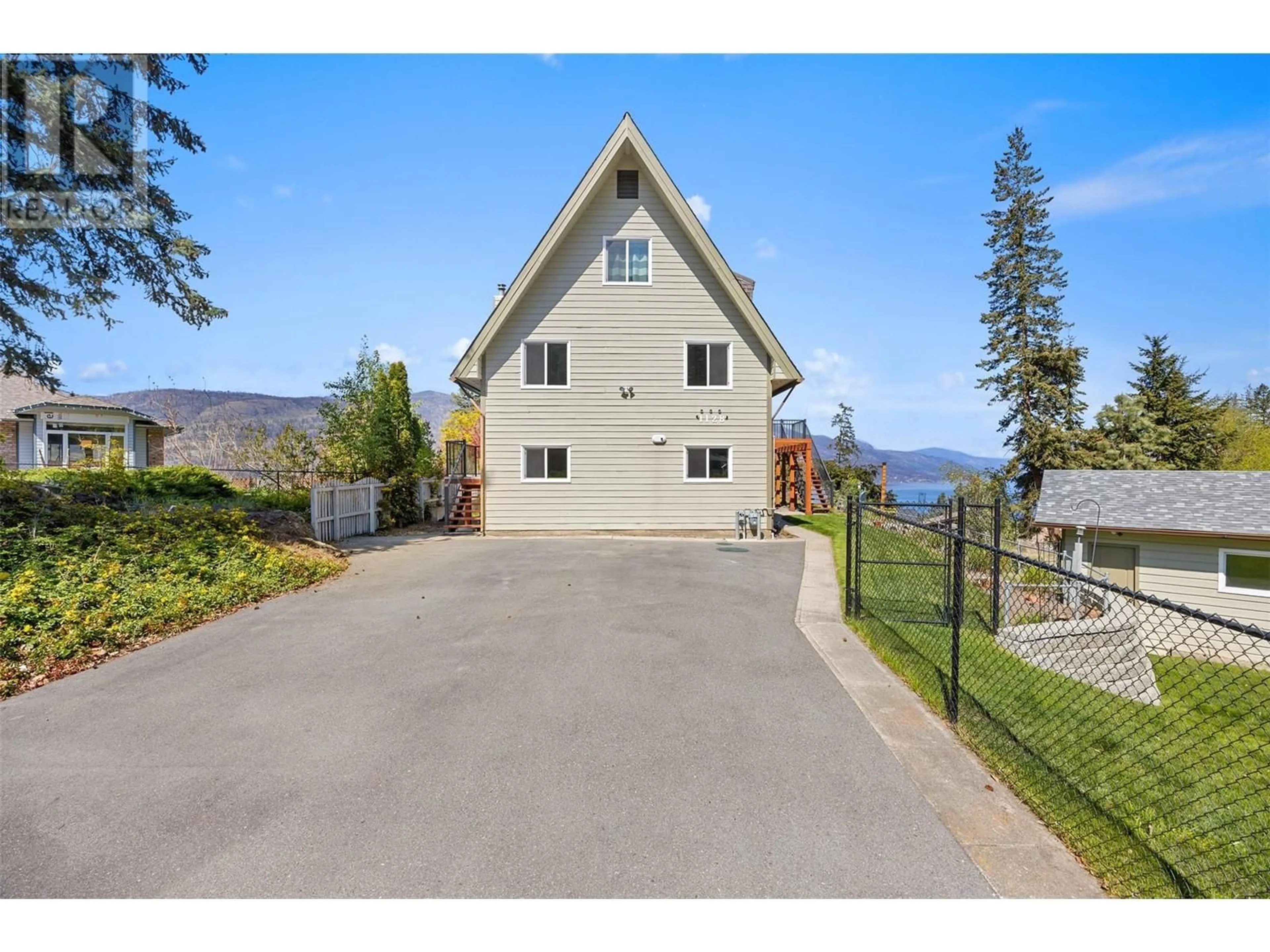 A pic from outside/outdoor area/front of a property/back of a property/a pic from drone, water/lake/river/ocean view for 1128 LYNN COURT, Kelowna British Columbia V1V1H1