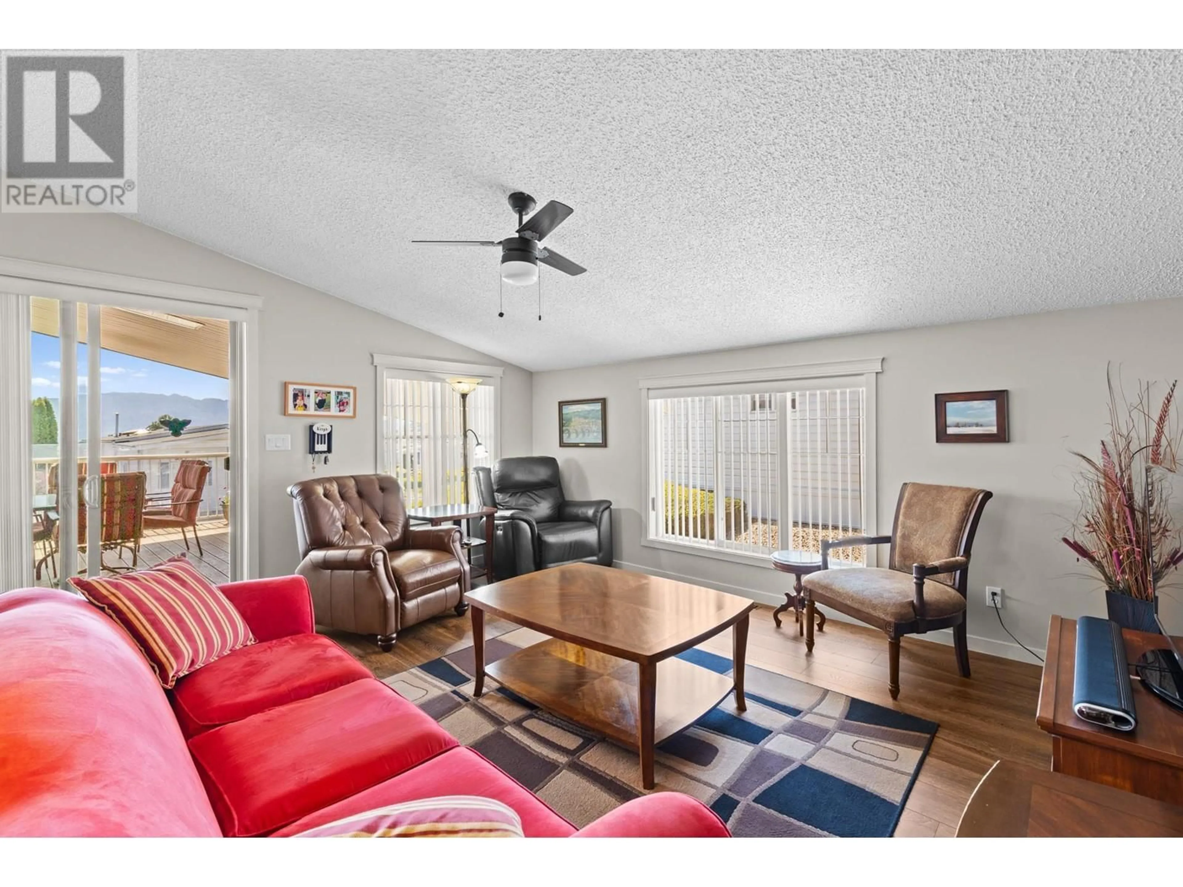 Living room with furniture, wood/laminate floor for 110 - 1850 SHANNON LAKE ROAD, West Kelowna British Columbia V4T1L6