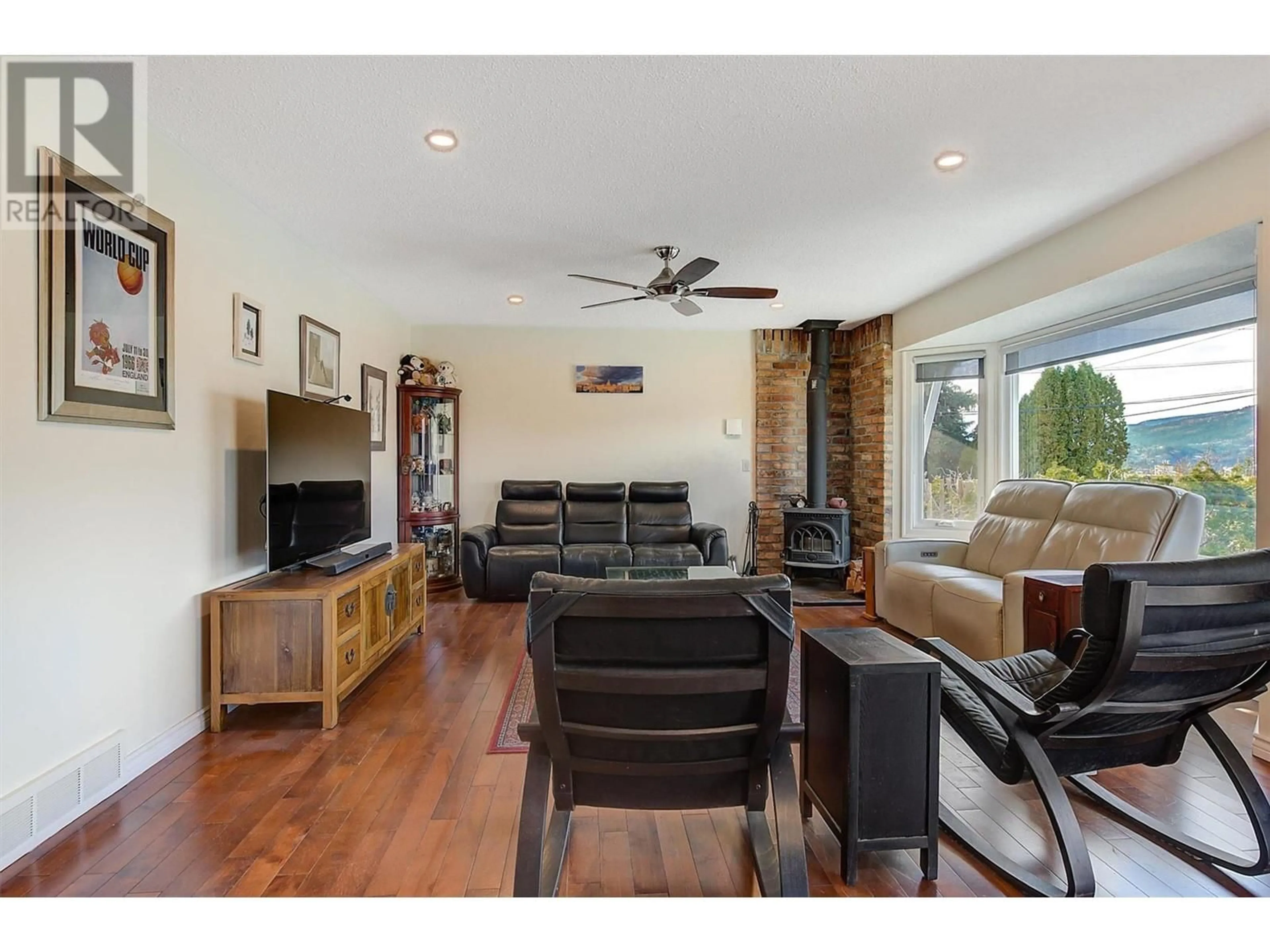 Living room with furniture, wood/laminate floor for 2415 COLLINGWOOD ROAD, West Kelowna British Columbia V1Z2C3