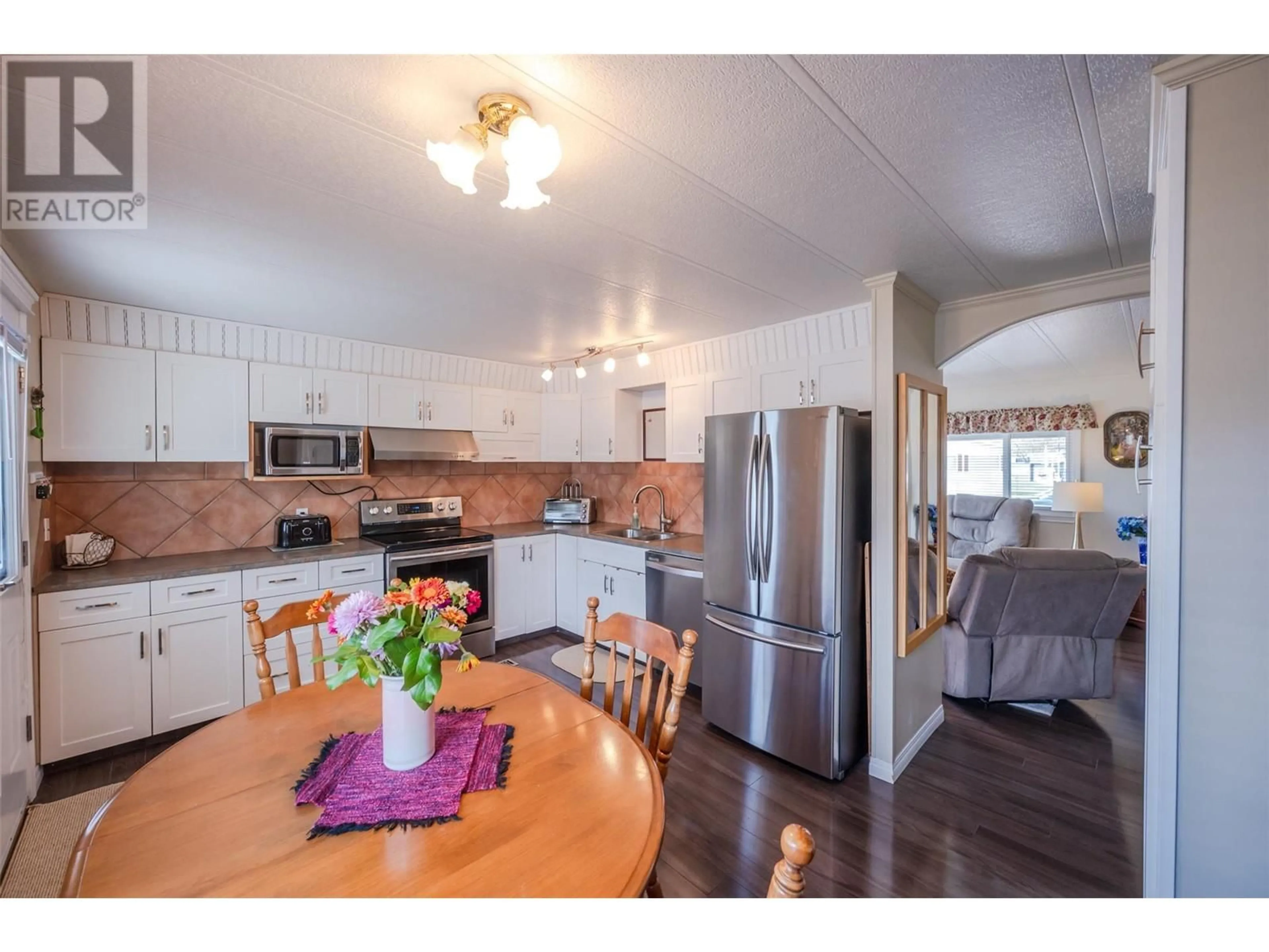 Open concept kitchen, wood/laminate floor for 308 - 321 YORKTON AVENUE, Penticton British Columbia V2A3V6
