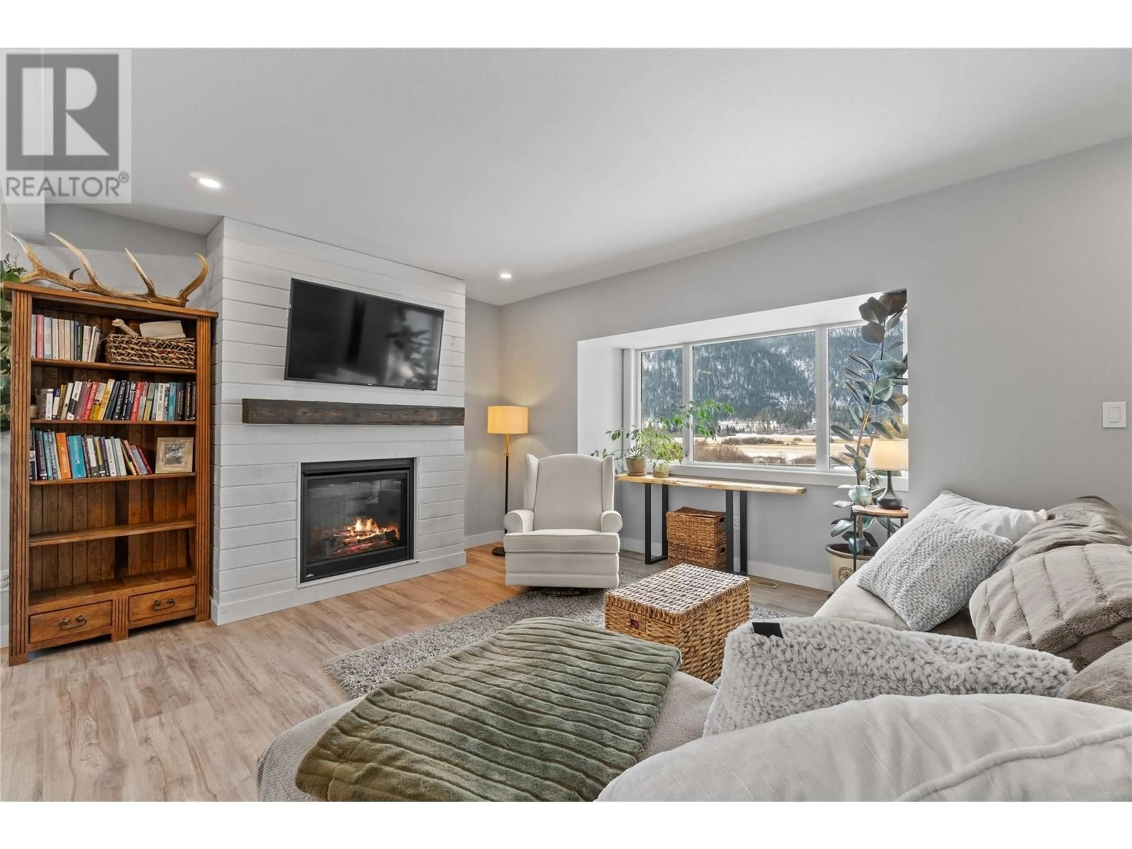 Living room with furniture, wood/laminate floor for 2939 WETASKIWIN ROAD, Falkland British Columbia V0E1W0
