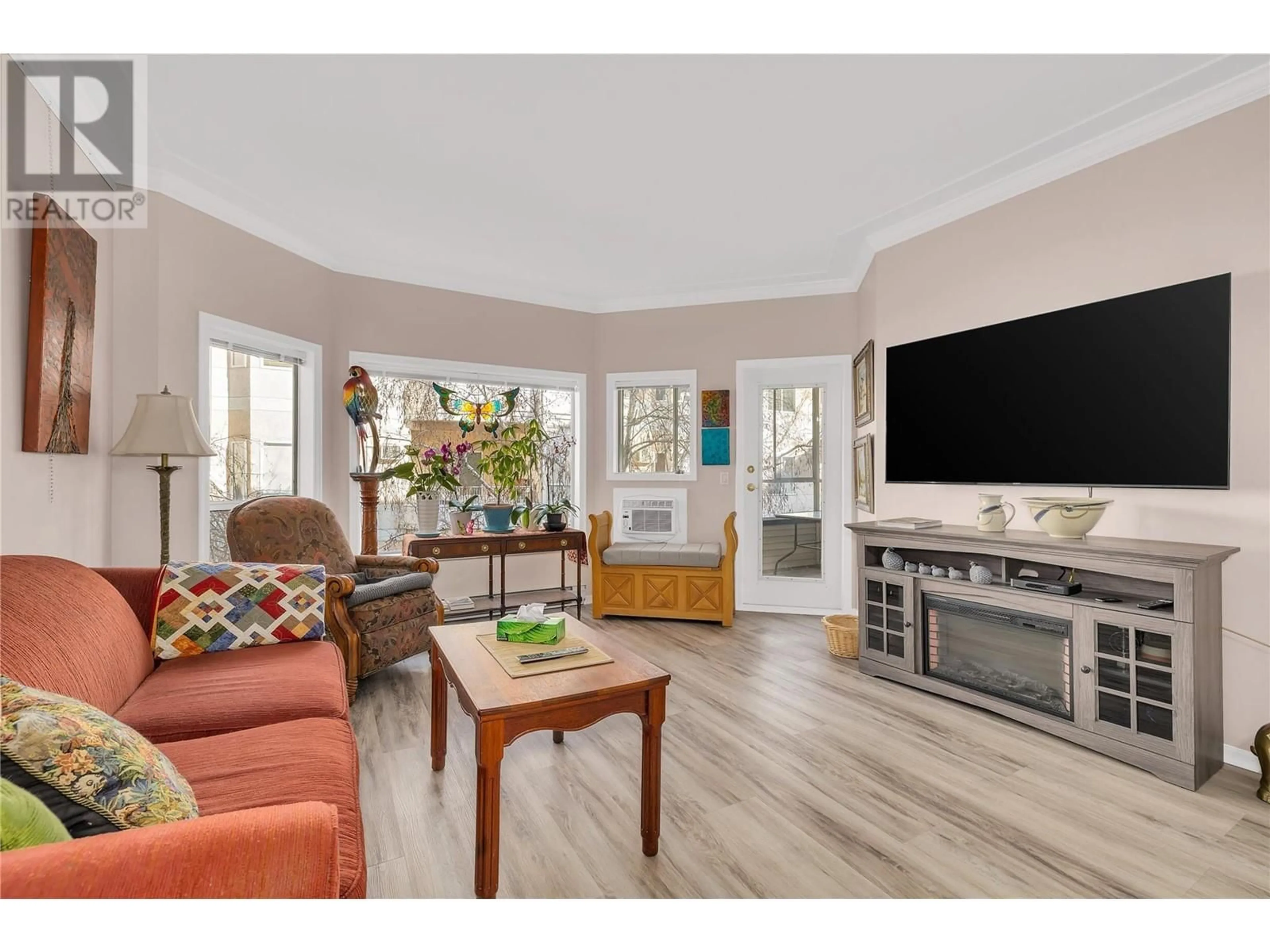 Living room with furniture, wood/laminate floor for 217 - 877 KLO ROAD, Kelowna British Columbia V1Y9R1