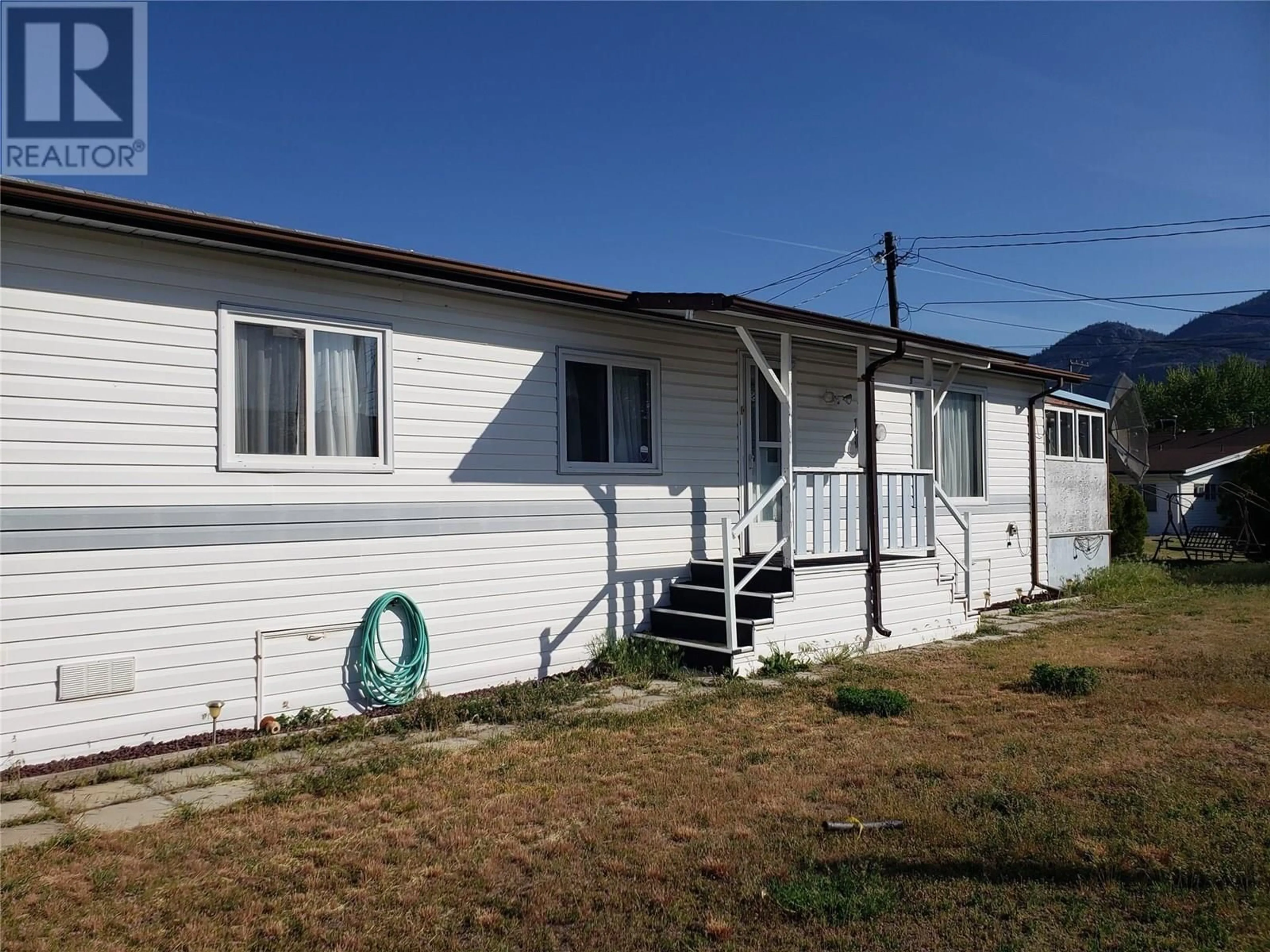 Home with vinyl exterior material, street for 6A - 9904 74TH AVENUE, Osoyoos British Columbia V0H1V5