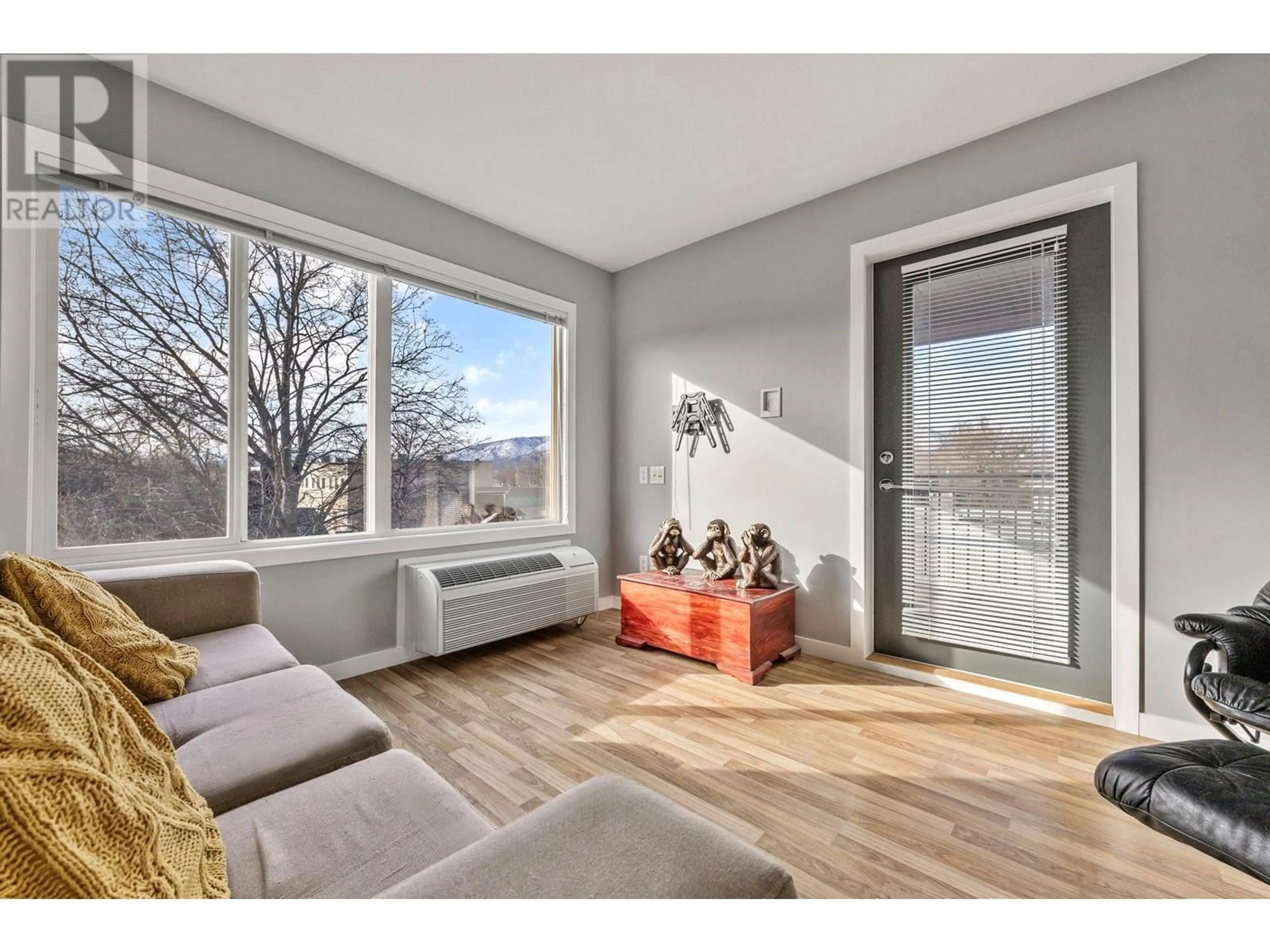 Living room with furniture, wood/laminate floor for 222 - 1550 DICKSON AVENUE, Kelowna British Columbia V1Y9Y8