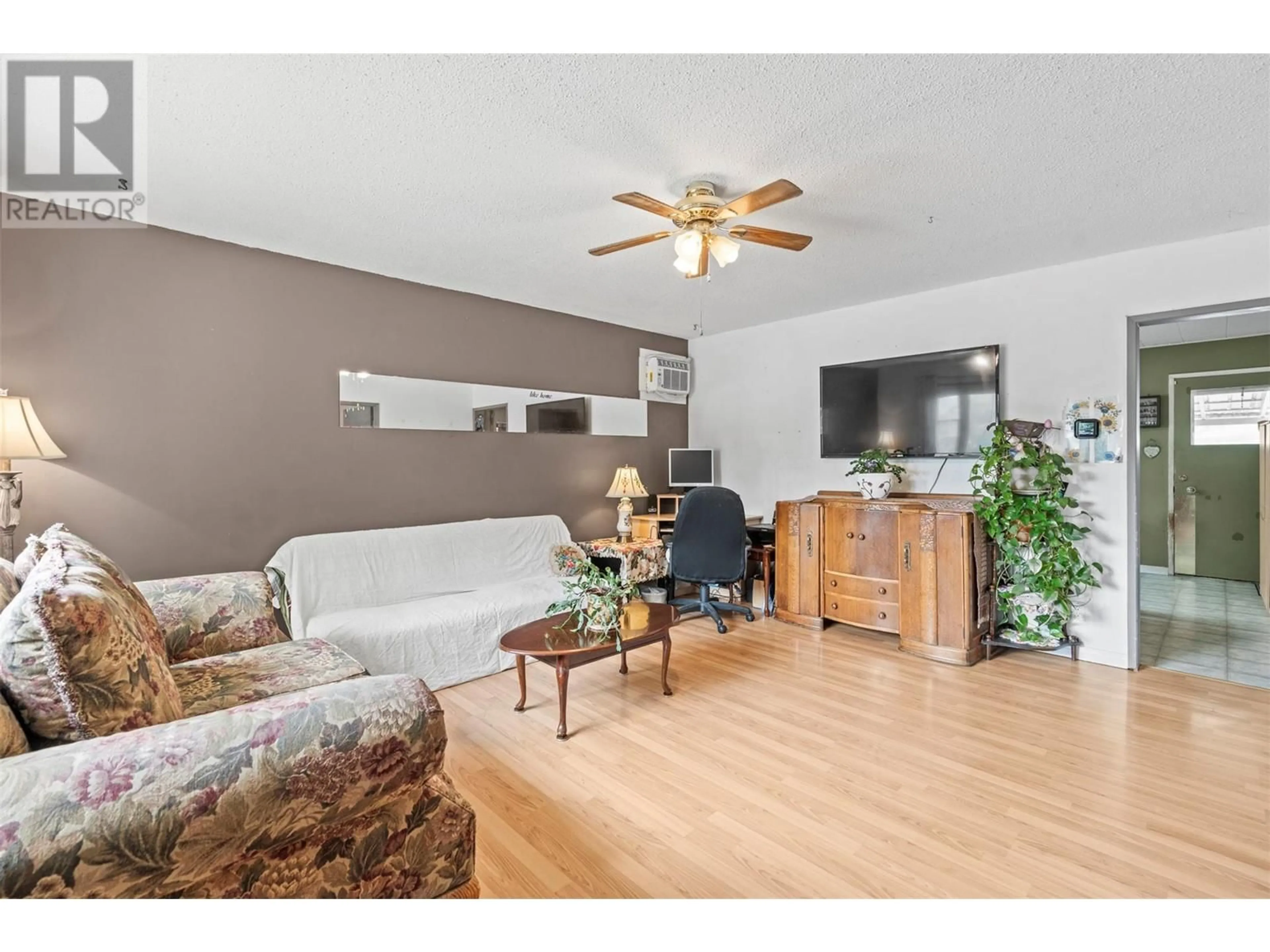 Living room with furniture, wood/laminate floor for 1809 46 AVENUE, Vernon British Columbia V1T3P4