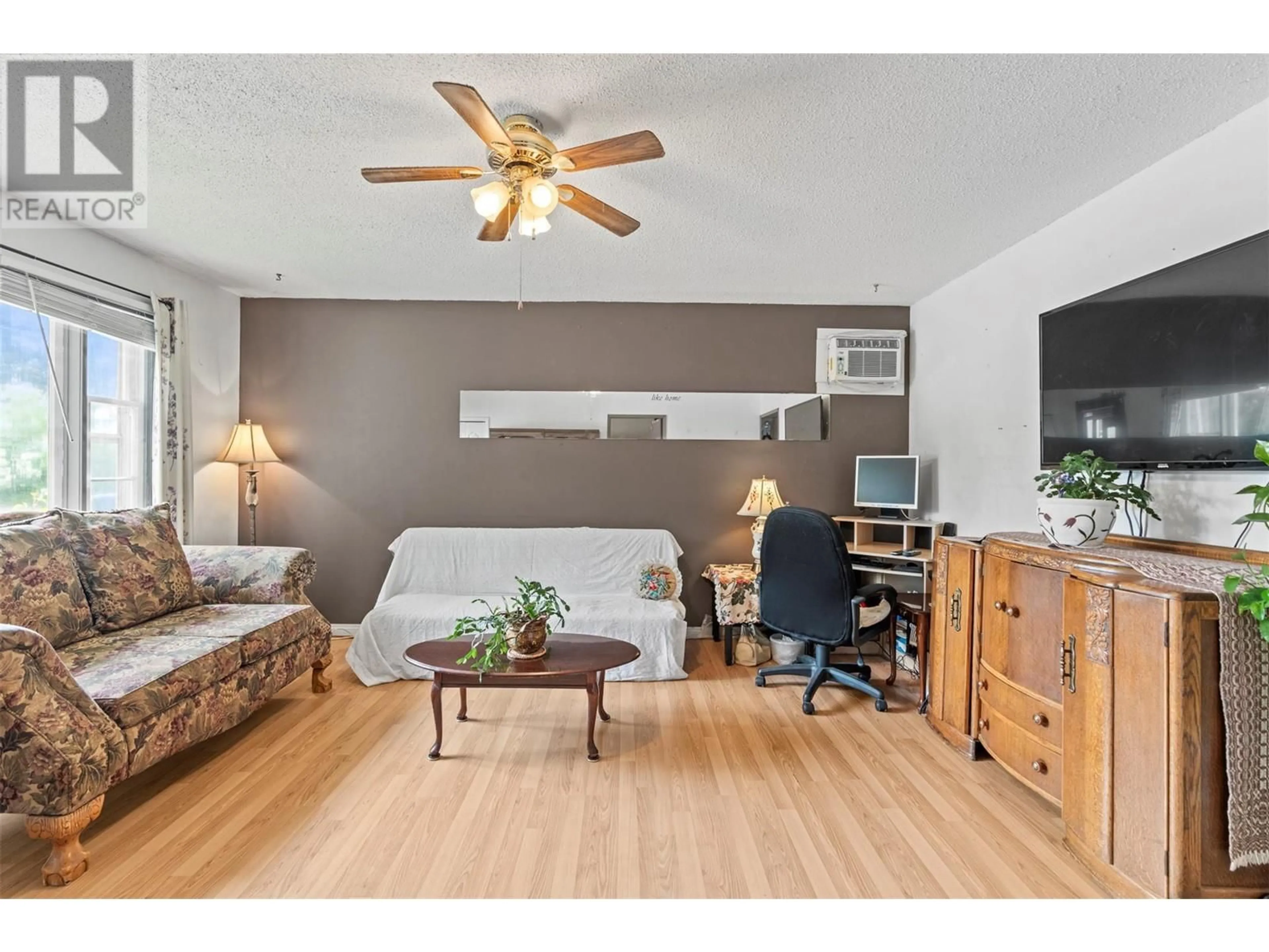 Living room with furniture, wood/laminate floor for 1809 46 AVENUE, Vernon British Columbia V1T3P4