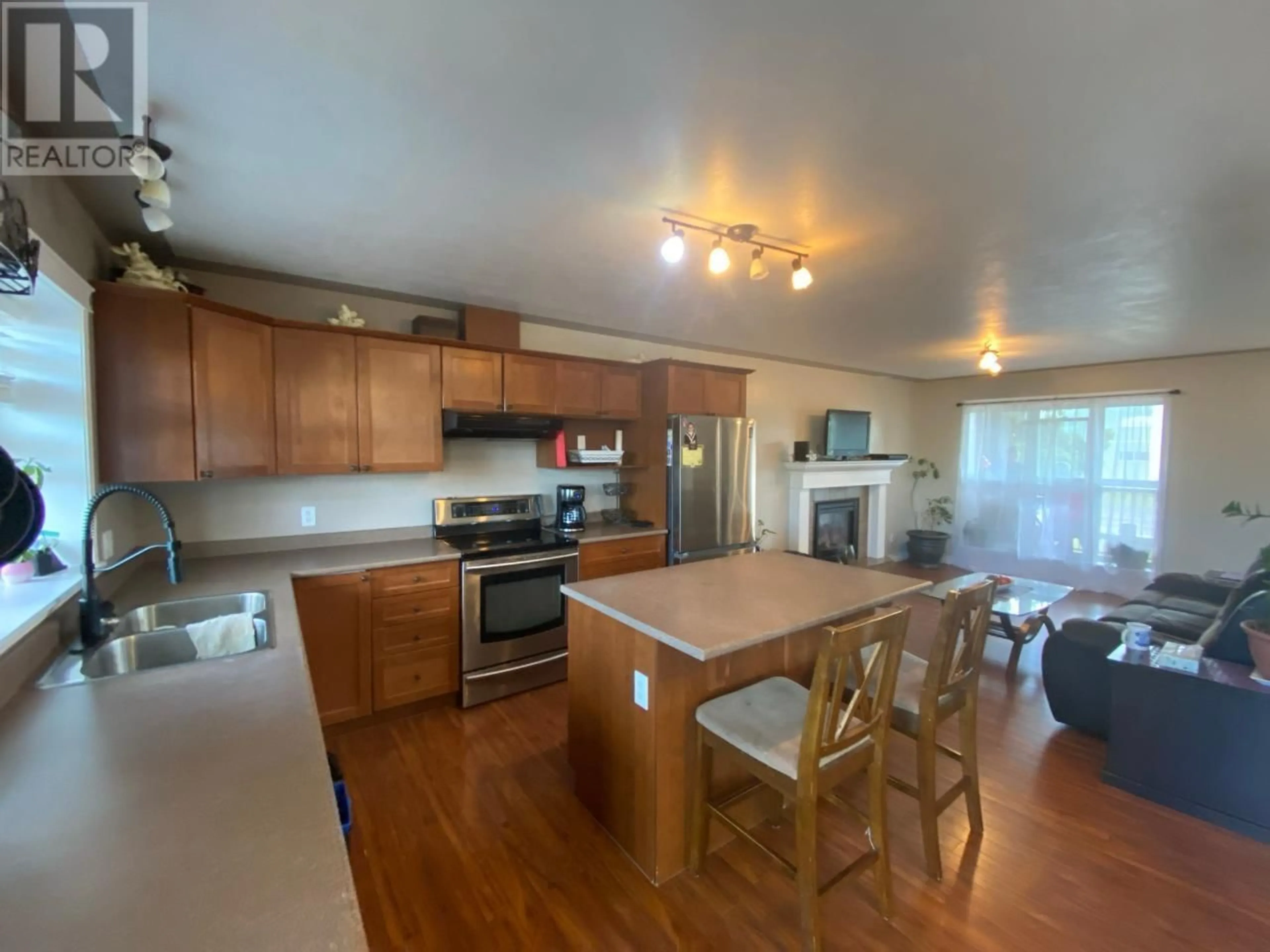 Open concept kitchen, wood/laminate floor for 1620 108 AVENUE, Dawson Creek British Columbia V1G2T6