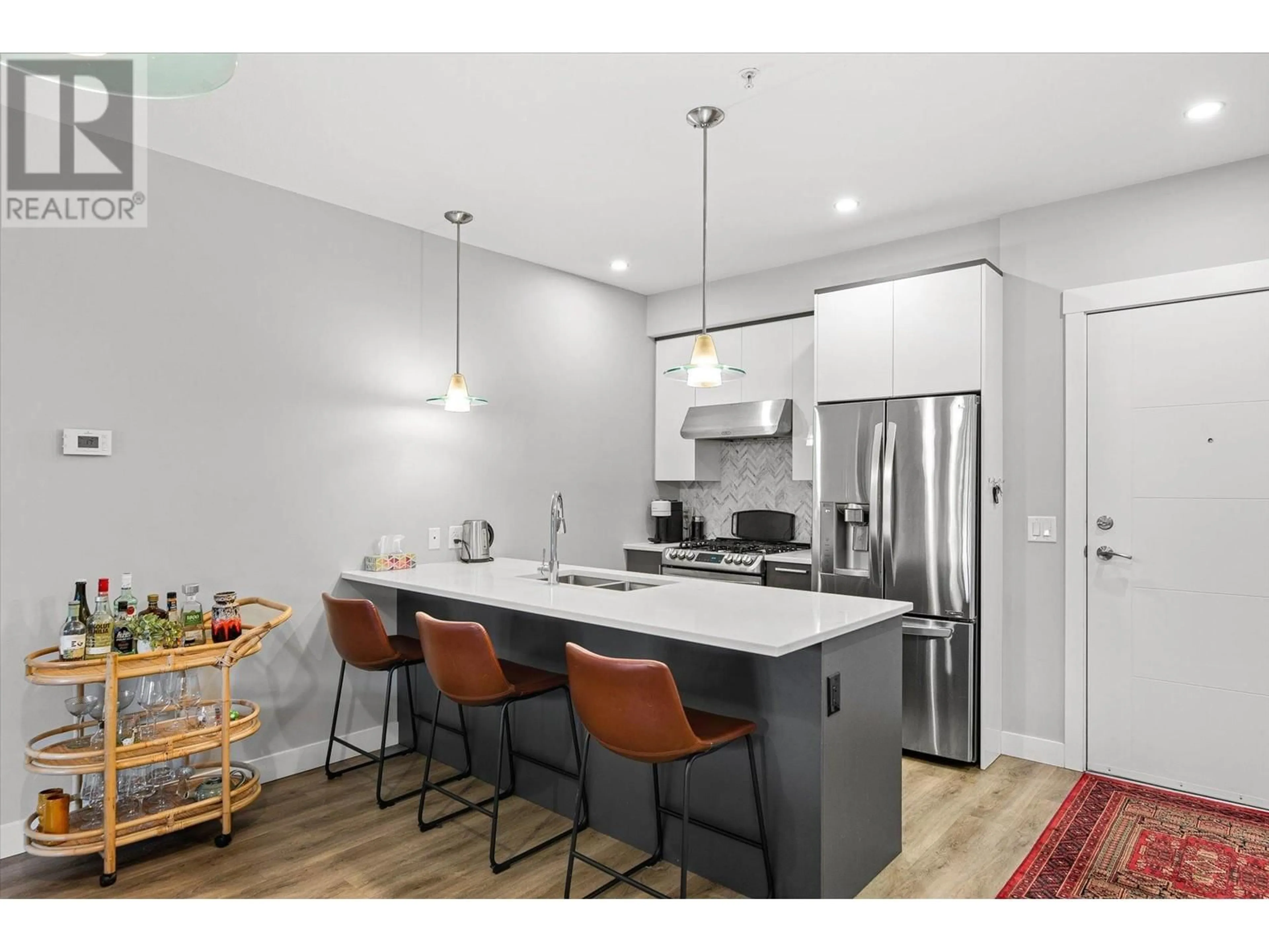 Open concept kitchen, wood/laminate floor for 105 - 1883 WATER STREET, Kelowna British Columbia V1Y1K4