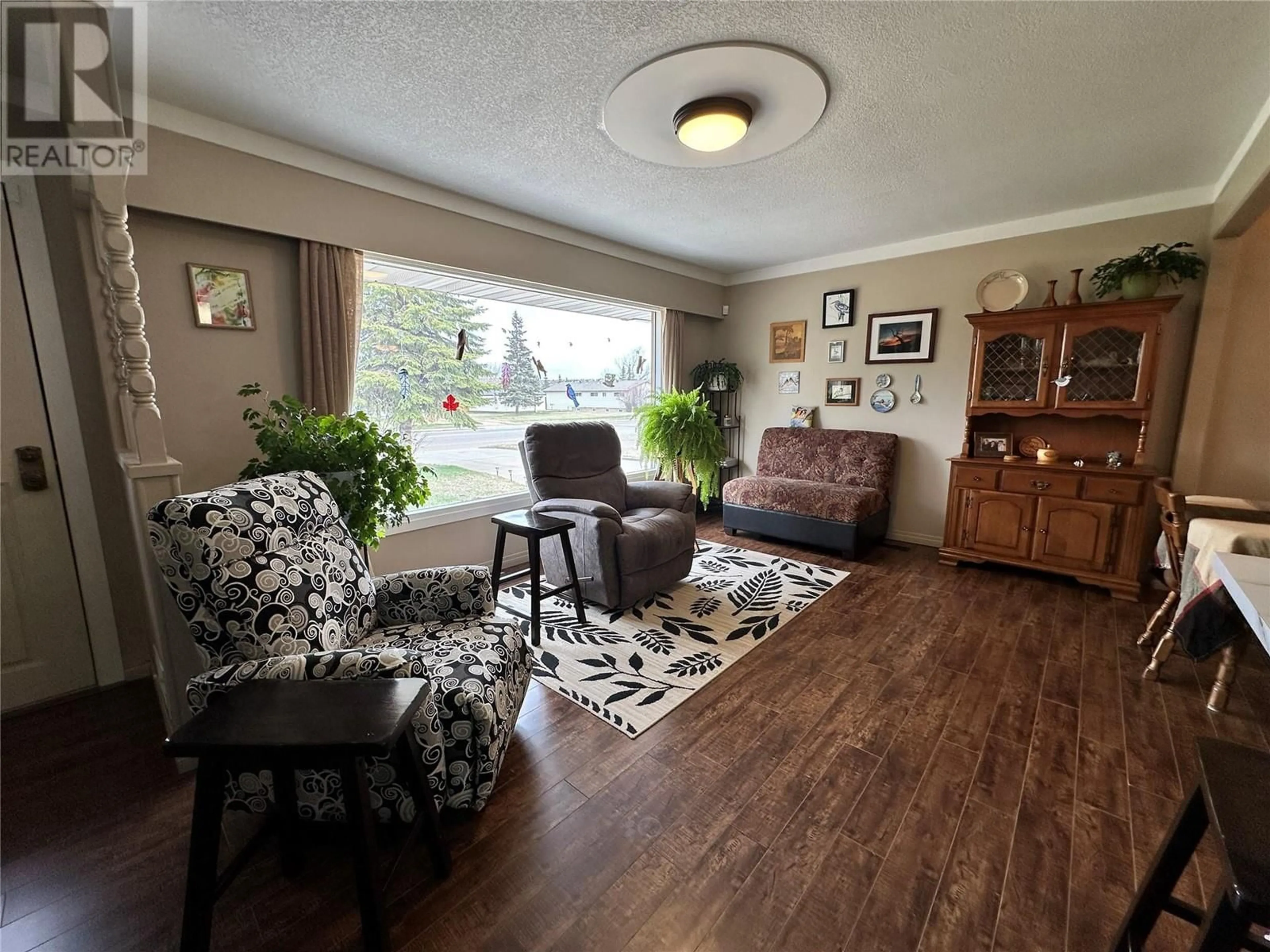 Living room with furniture, wood/laminate floor for 1509 108 AVENUE, Dawson Creek British Columbia V1G2T5