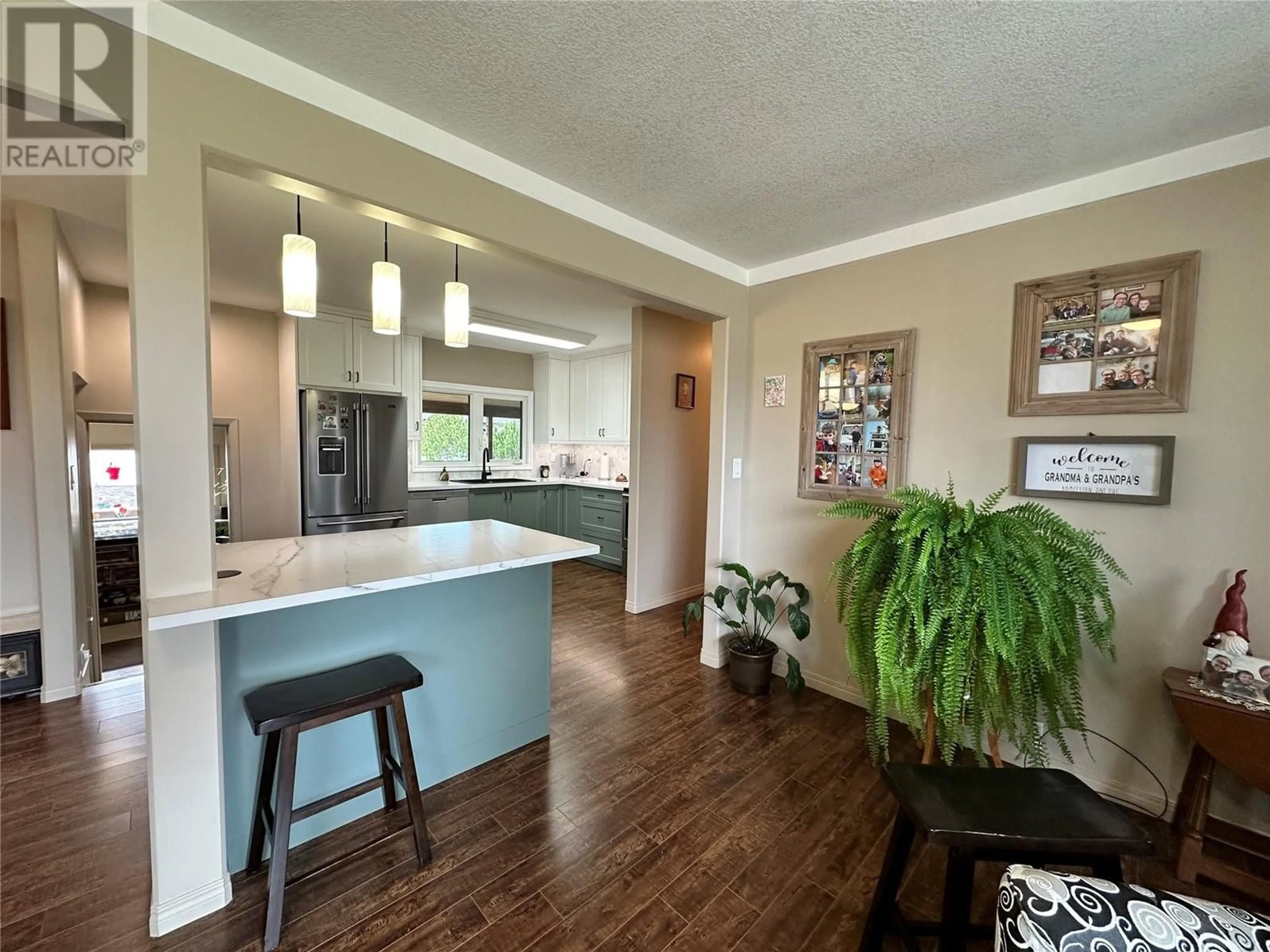 Open concept kitchen, wood/laminate floor for 1509 108 AVENUE, Dawson Creek British Columbia V1G2T5