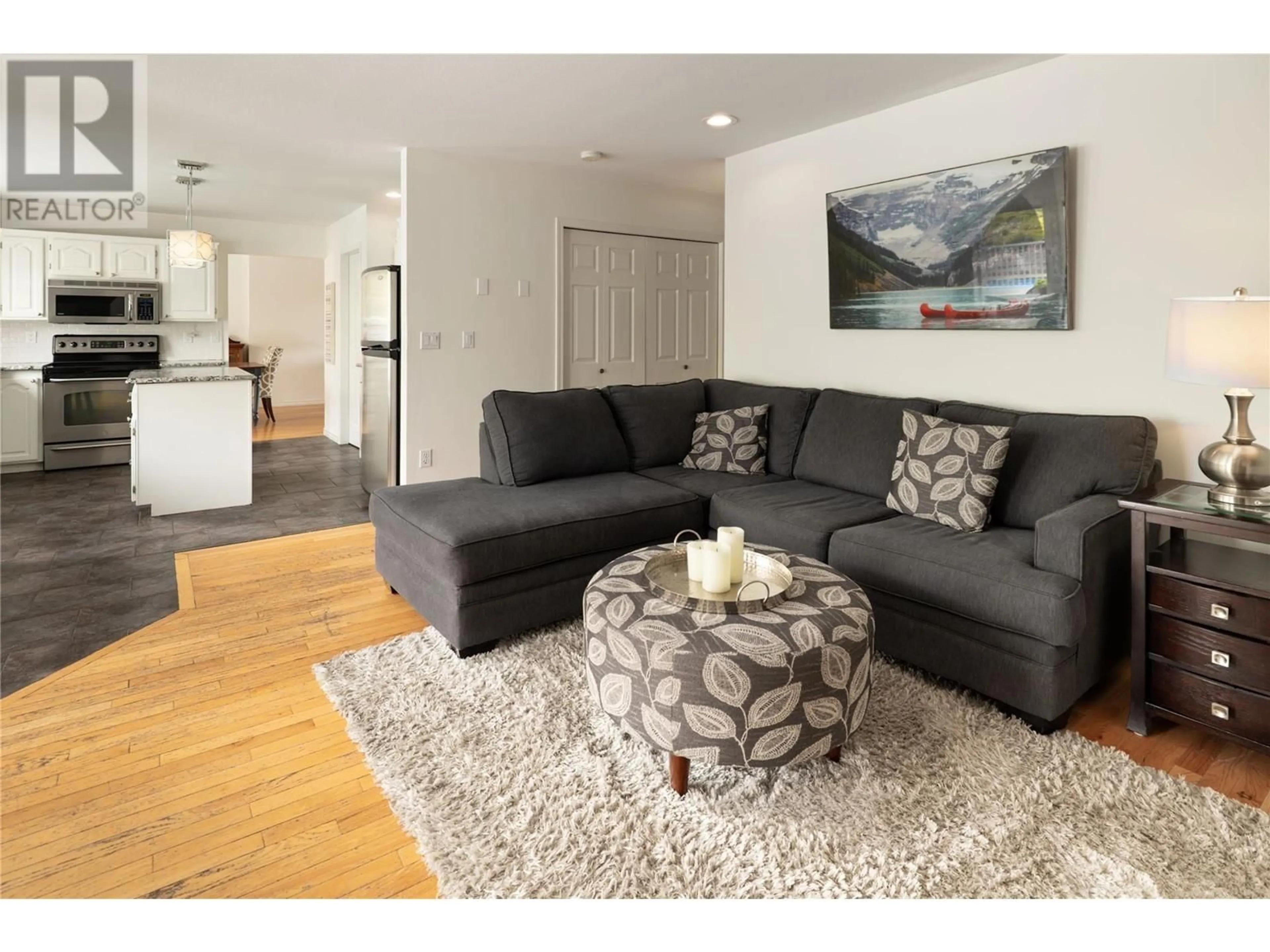 Living room with furniture, wood/laminate floor for 438 CURLEW DRIVE, Kelowna British Columbia V1W4L2