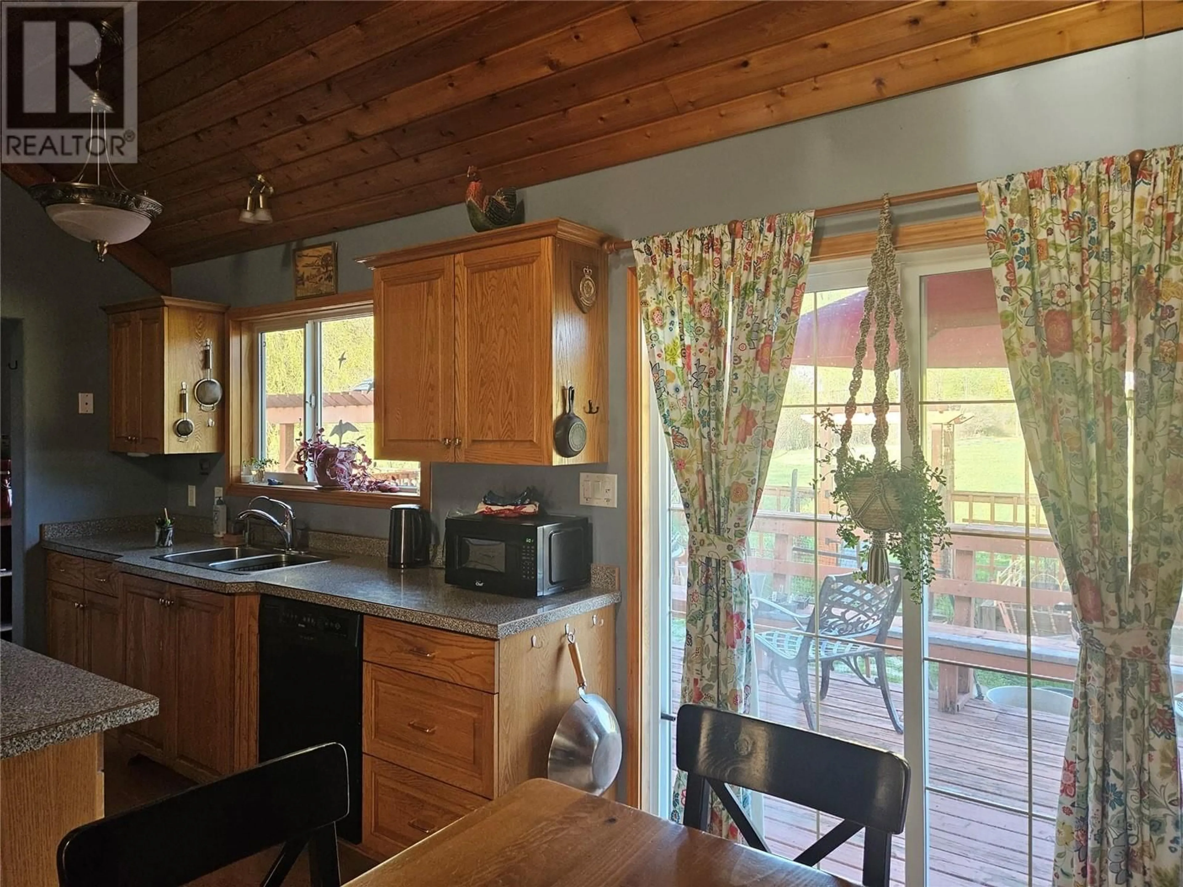 Open concept kitchen, wood/laminate floor for 695 BROUSE LOOP ROAD, Nakusp British Columbia V0G1R1